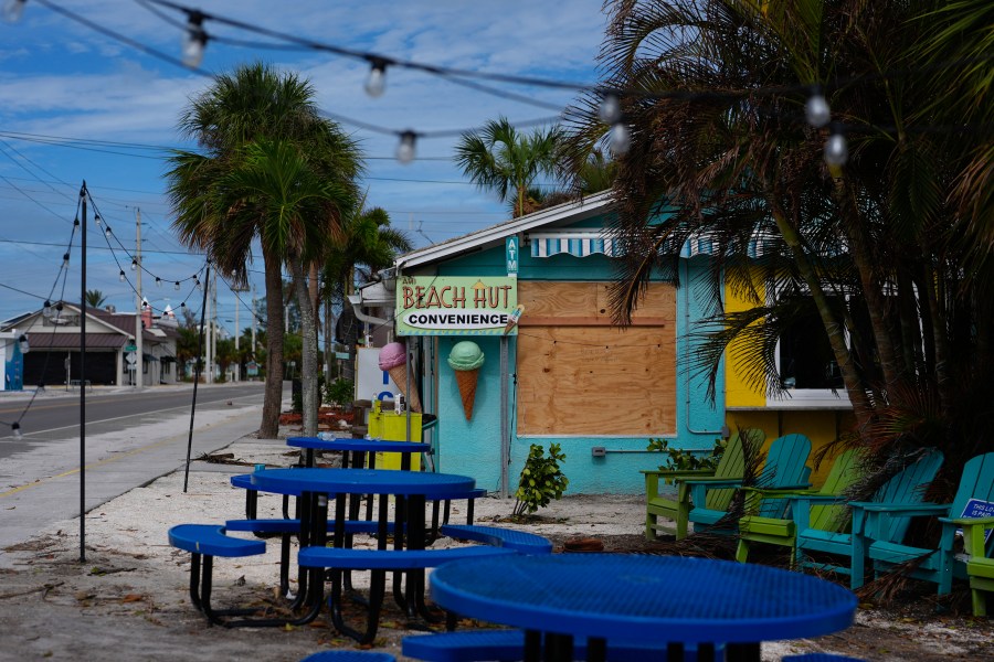 FILE - A boarded up business stands beside a deserted street in an evacuation zone, ahead of the arrival of Hurricane Milton, in Anna Maria, Fla., on Anna Maria Island, Oct. 8, 2024. (AP Photo/Rebecca Blackwell, File)