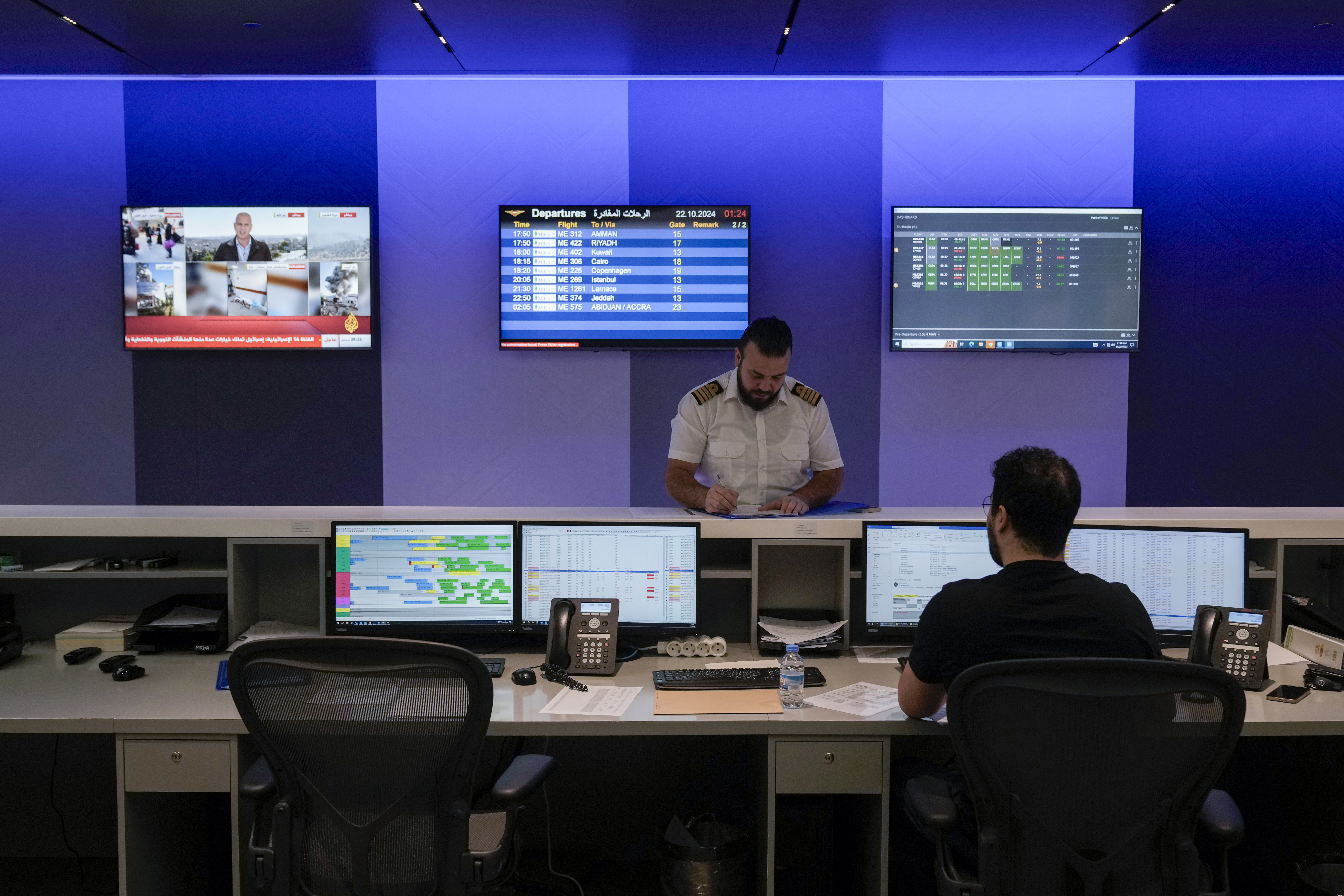 Middle East Airlines employees work in the operations room at the MEA offices in Beirut, Tuesday, Oct. 22, 2024. (AP Photo/Bilal Hussein)