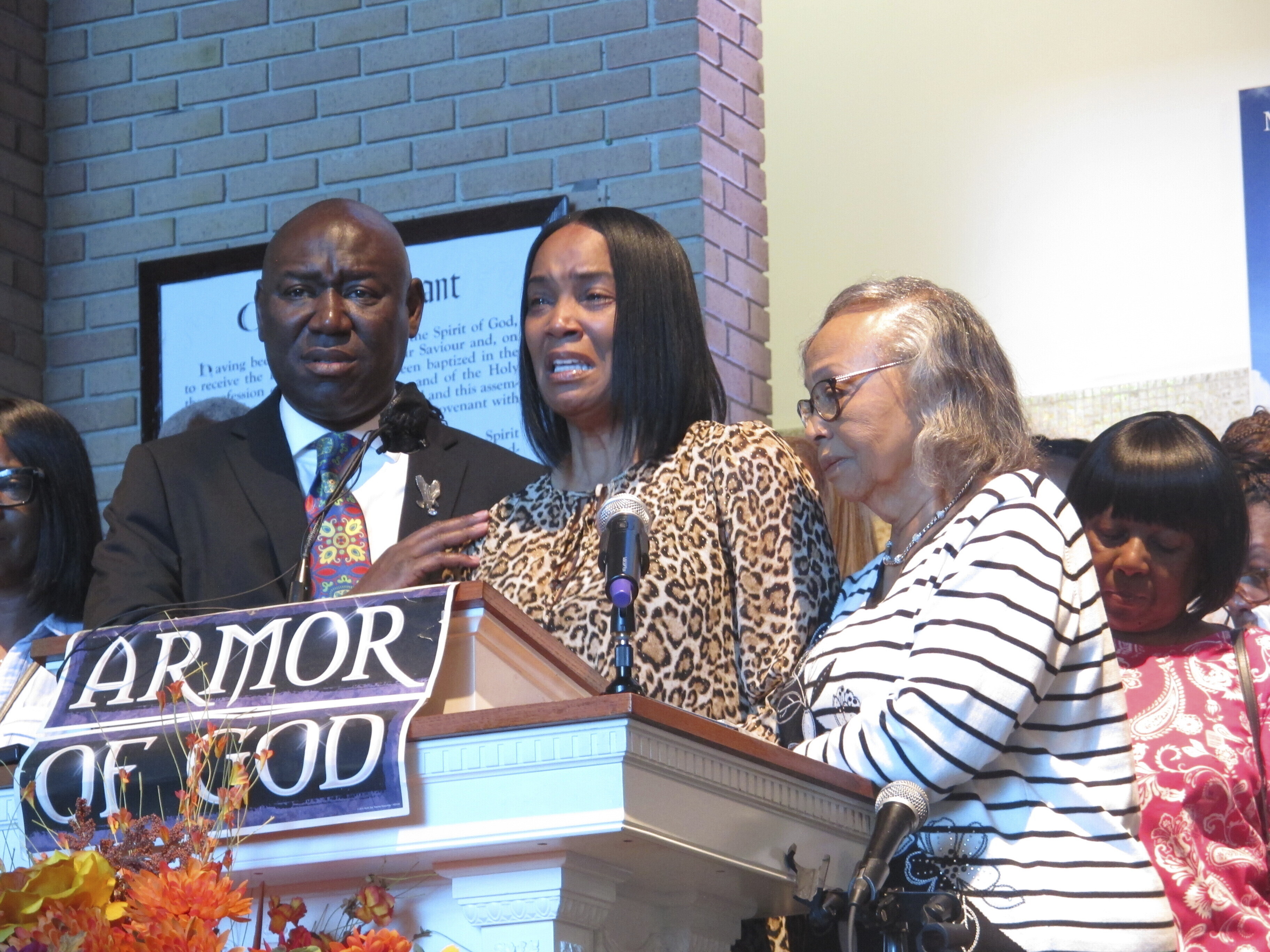 Regina Brinson, center, weeps at a news conference Tuesday, Oct. 22, 2024, while speaking alongside her mother, Katrena Alexander and attorney Ben Crump during a news conference in Jacksonville, Fla. Crump represents families of three of the seven people killed when a ferry dock walkway collapsed on Sapelo Island, Ga., on Saturday, Oct. 19. (AP Photo/Russ Bynum)