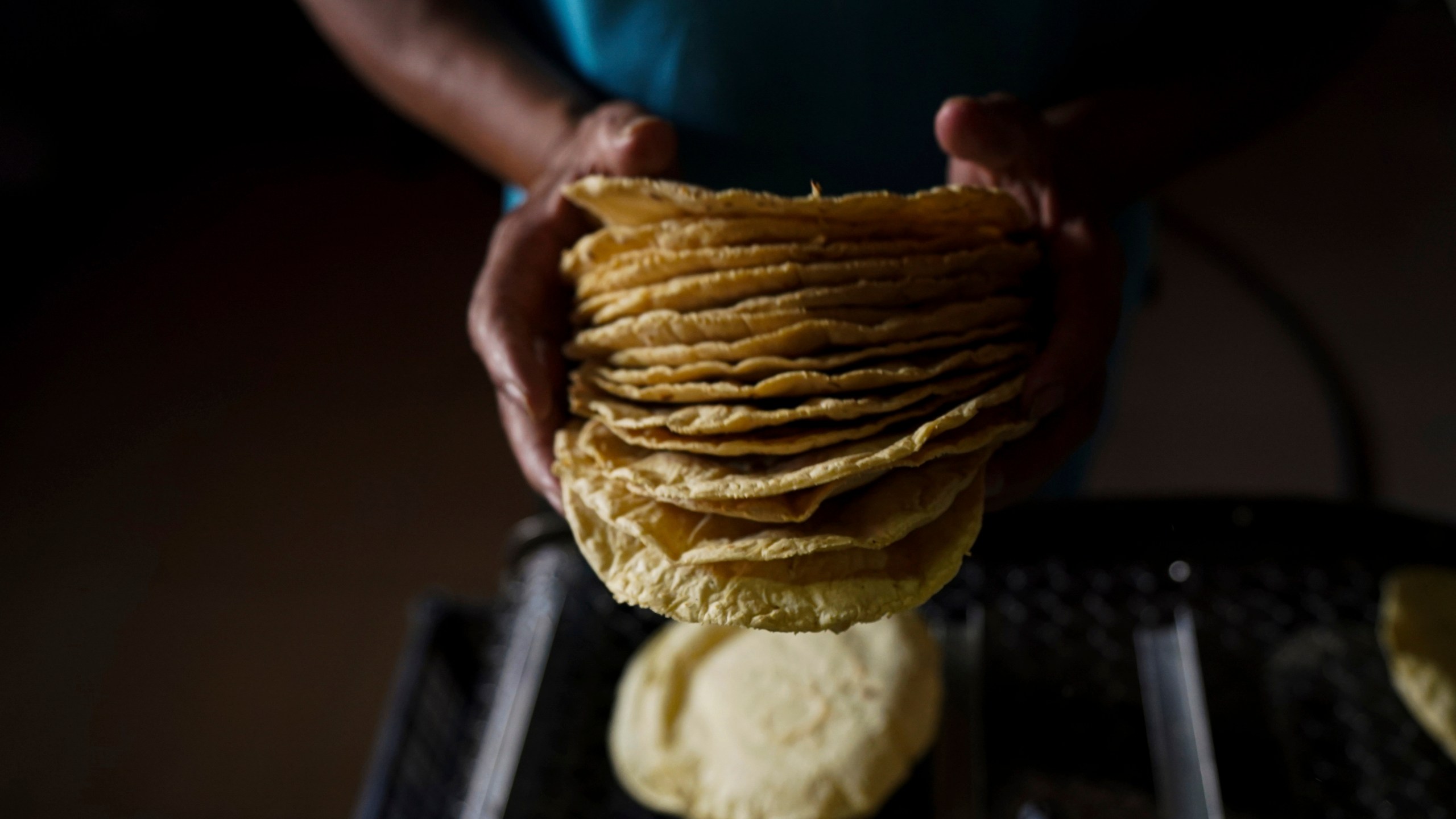 FILE - A worker packages tortillas to sell at a tortilla factory in Mexico City, May 9, 2022. (AP Photo/Fernando Llano, File)