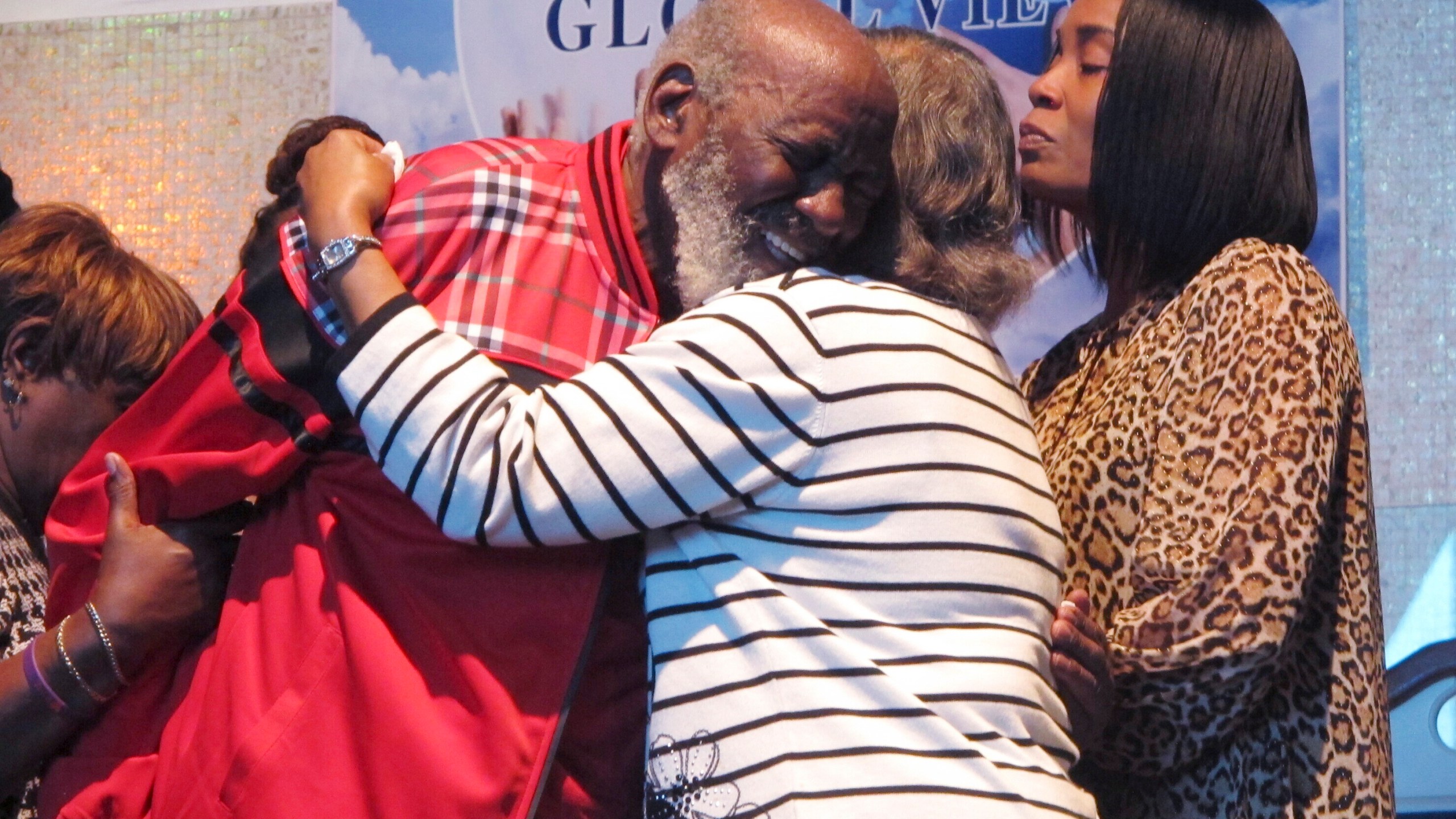 Wilbert Gardner, left, hugs Katrena Alexander while Alexander's daughter, Regina Brinson, right, looks on during a news conference Tuesday, Oct. 22, 2024, in Jacksonville, Fla, A dock gangway collapse happened as people were leaving a cultural festival on Sapelo Island, Georgia, on Saturday, Oct. 19, 2024. Alexander's brother, Isaiah Thomas, was among the dead. Gardner had a friend who was hospitalized with injuries. (AP Photo/Russ Bynum)