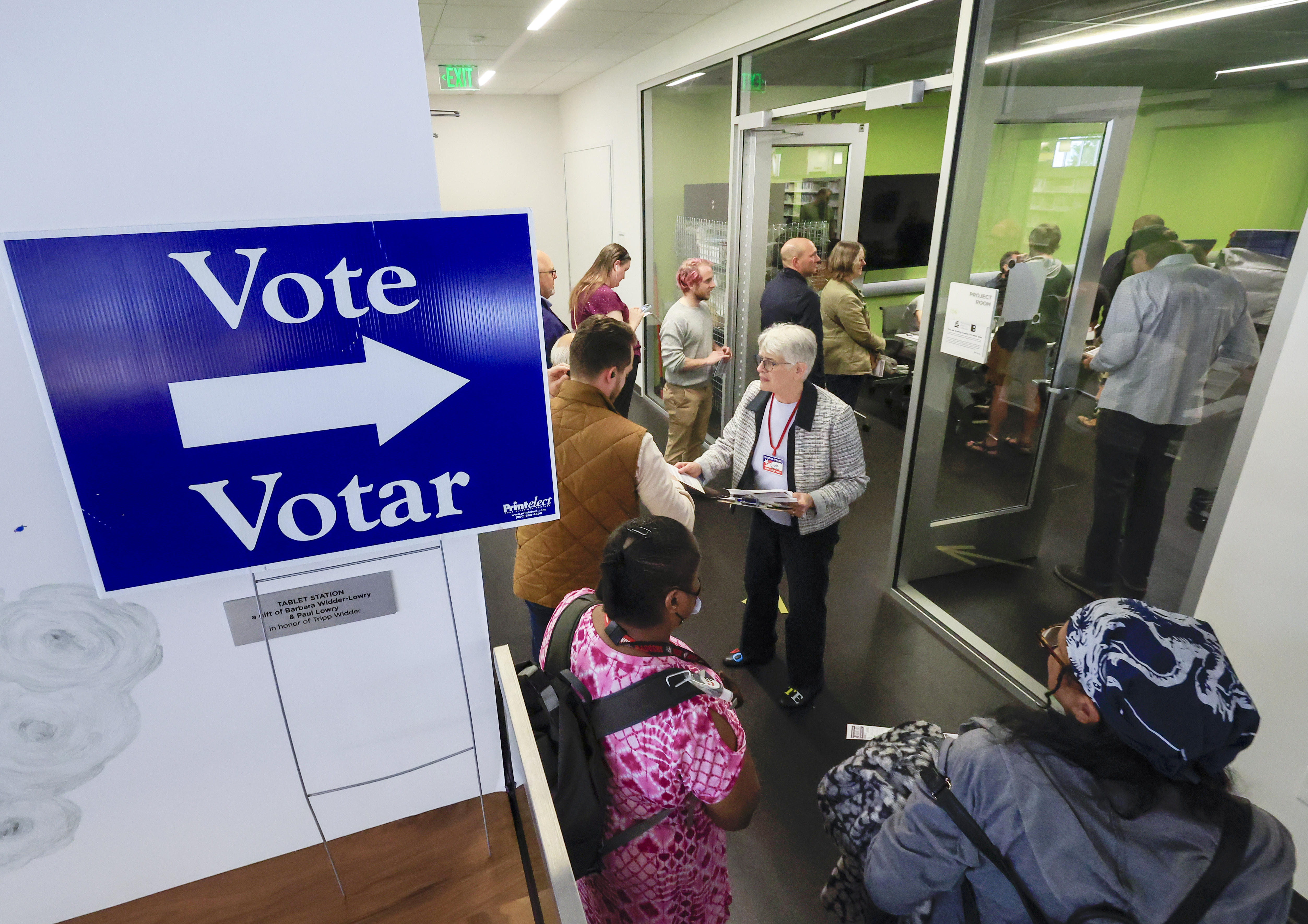 People lineup to vote on the first day of Wisconsin's in-person absentee voting at the Madison Public Library in Madison, Wisc., Tuesday, Oct. 22, 2024. (AP Photo/John Hart, Wisconsin State Journal)