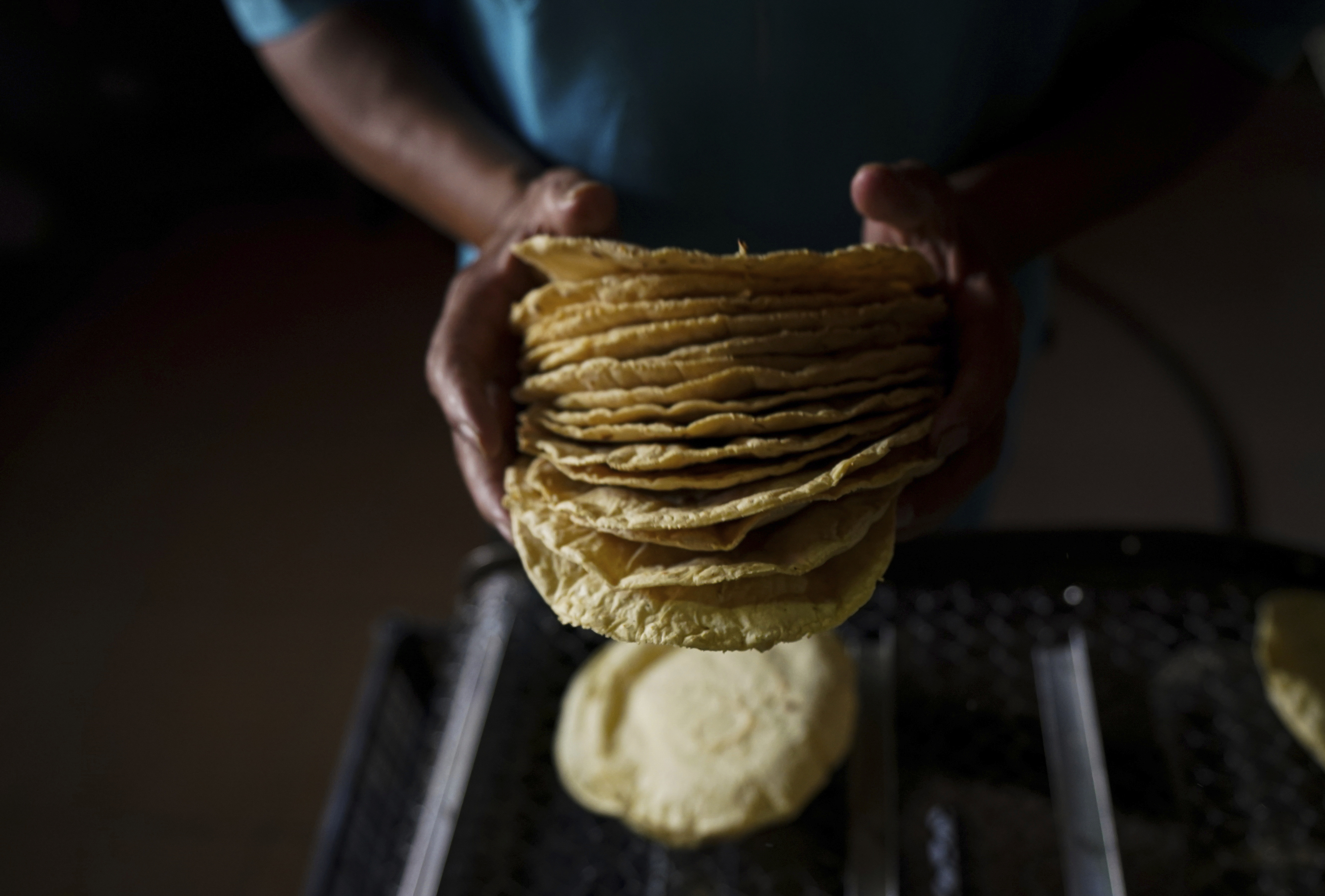 FILE - A worker packages tortillas to sell at a tortilla factory in Mexico City, May 9, 2022. (AP Photo/Fernando Llano, File)