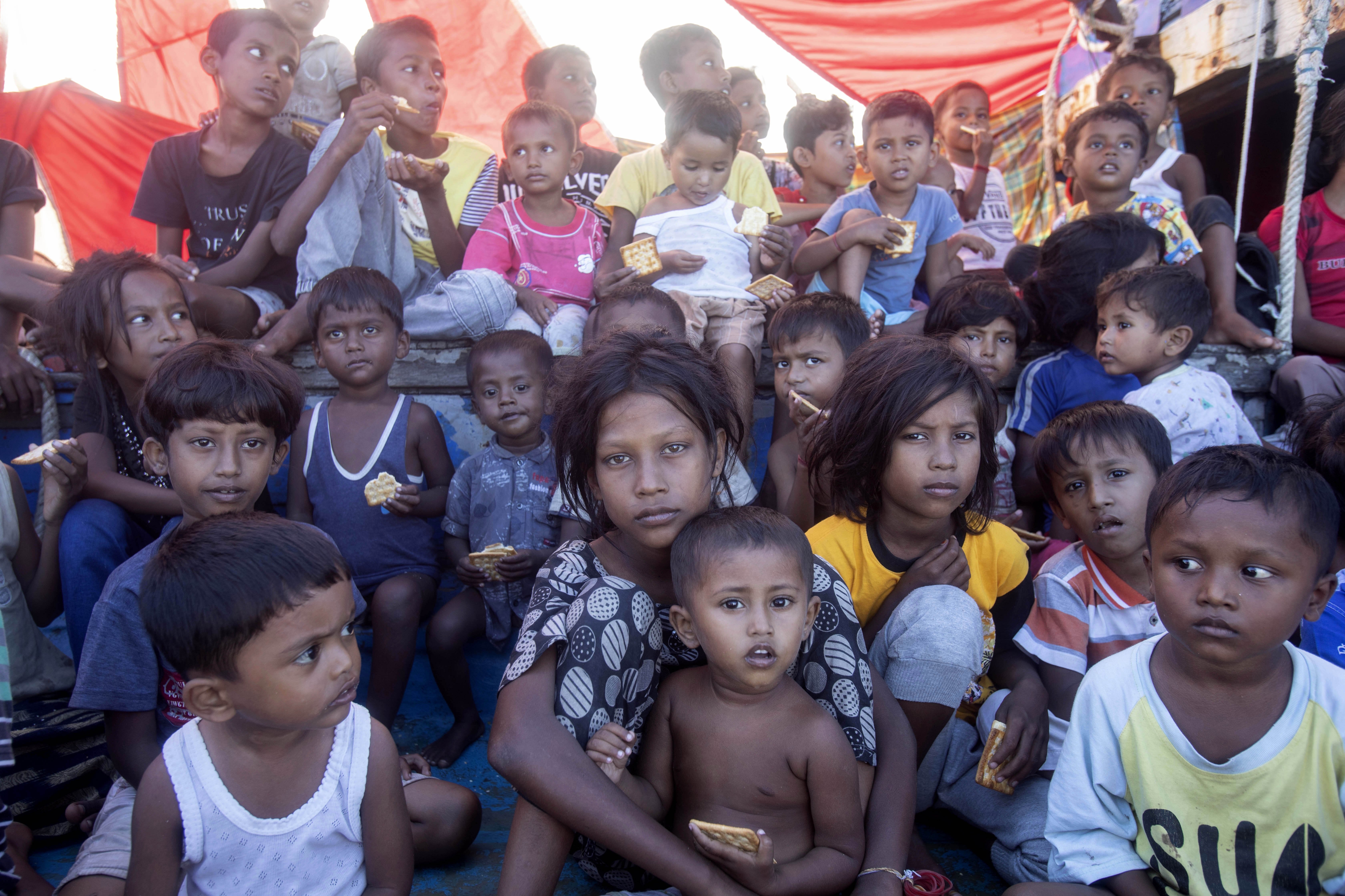 Rohingya refugee children sit on the deck of their boat anchored in the waters near the coast of Labuhan Haji, Aceh province, Indonesia, Tuesday, Oct. 22, 2024. (AP Photo/Binsar Bakkara)