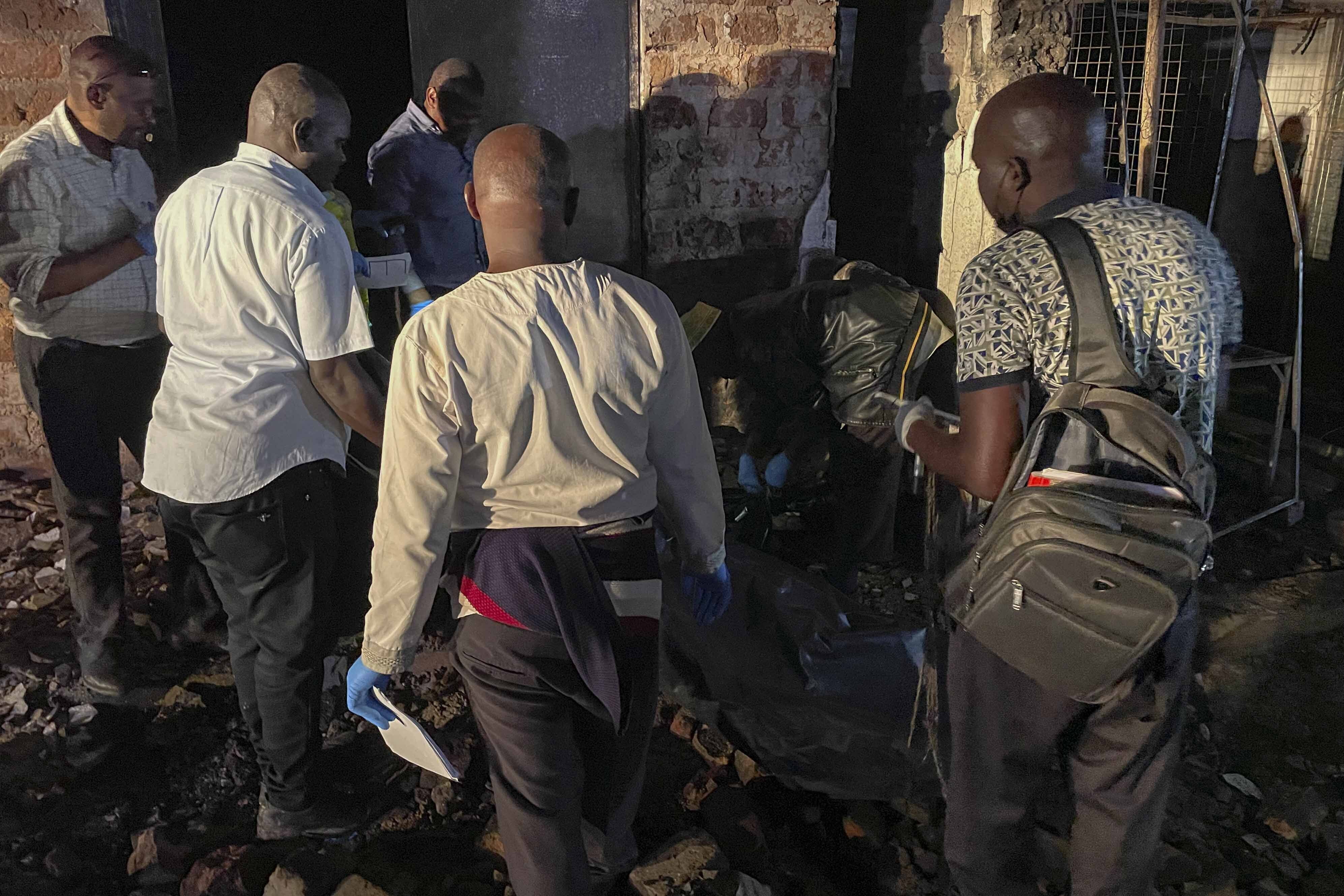 Uganda forensic officials inspect the site where a fuel truck exploded, on the outskirts of Kampala, Uganda, Tuesday, Oct. 22, 2024. (AP Photo)