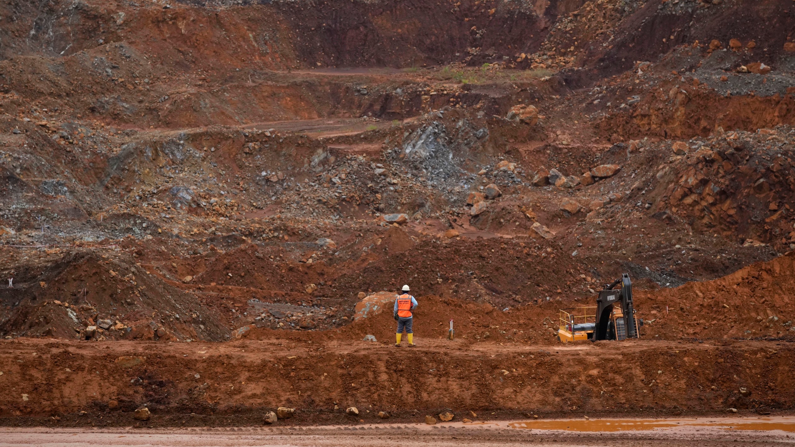 FILE - A worker stands near a mining pit at PT Vale Indonesia's nickel mine in Sorowako, South Sulawesi, Indonesia, on Sept. 12, 2023. (AP Photo/Dita Alangkara, File)