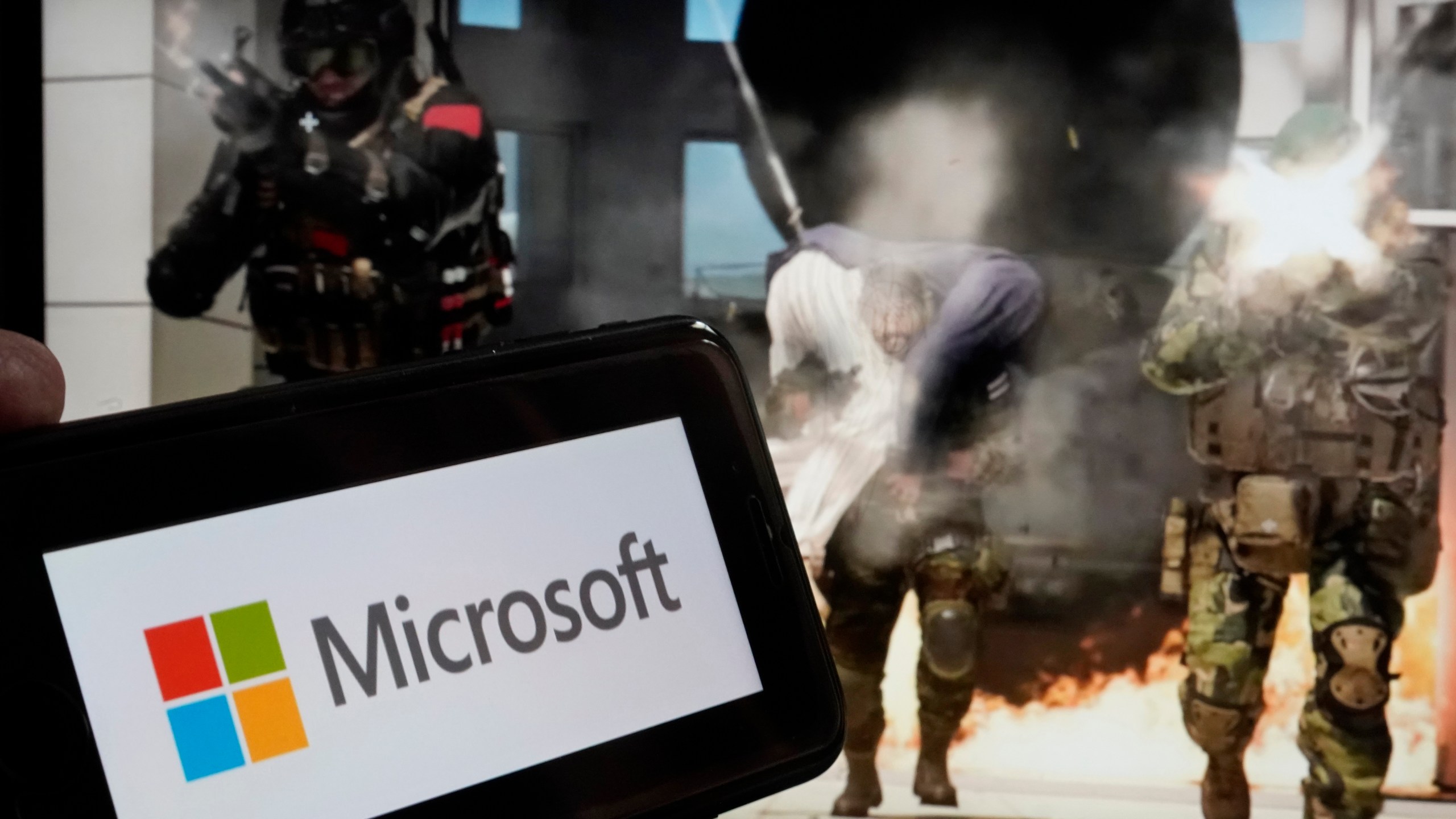 FILE - The logo for Microsoft, and a scene from Activision "Call of Duty - Modern Warfare," are shown in this photo, in New York, June 21, 2023. (AP Photo/Richard Drew, File)