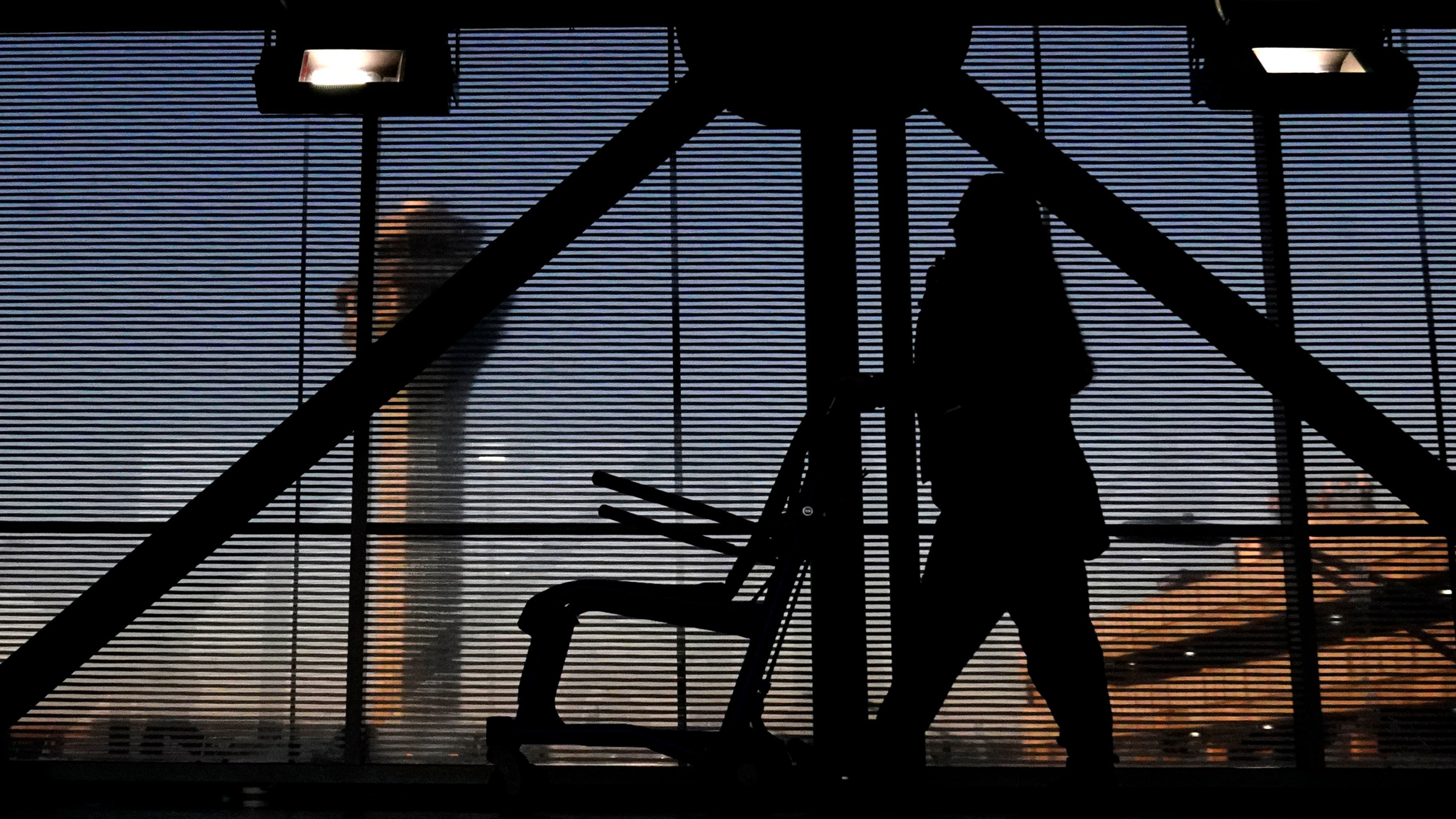 FILE - An airline employee transfers a wheelchair to her station at O'Hare International Airport in Chicago, Nov. 23, 2022. (AP Photo/Nam Y. Huh, File)