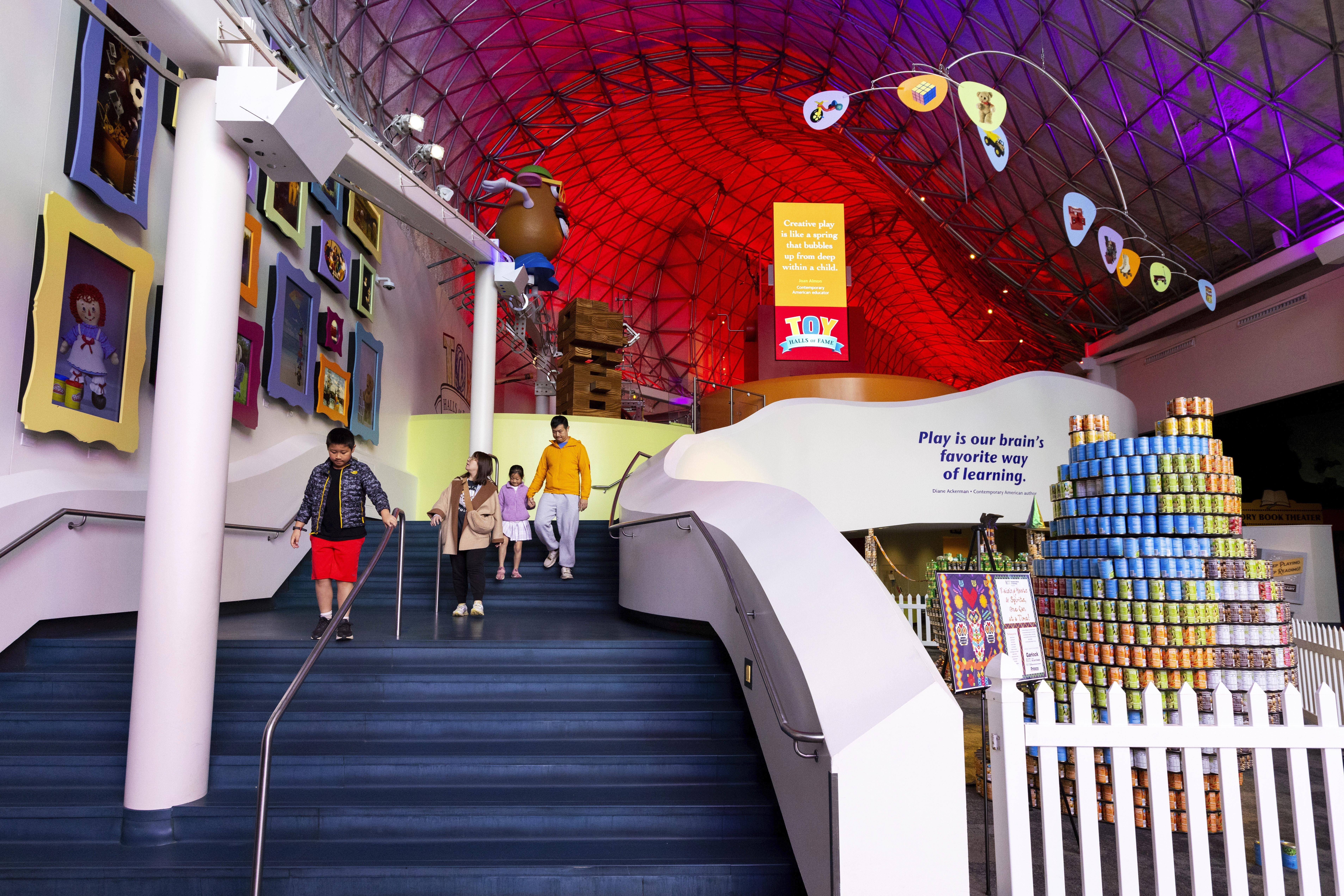 Visitors walk through the Toy Hall of Fame inside The Strong National Museum of Play, Tuesday, Oct. 15, 2024, in Rochester, N.Y. (AP Photo/Lauren Petracca)