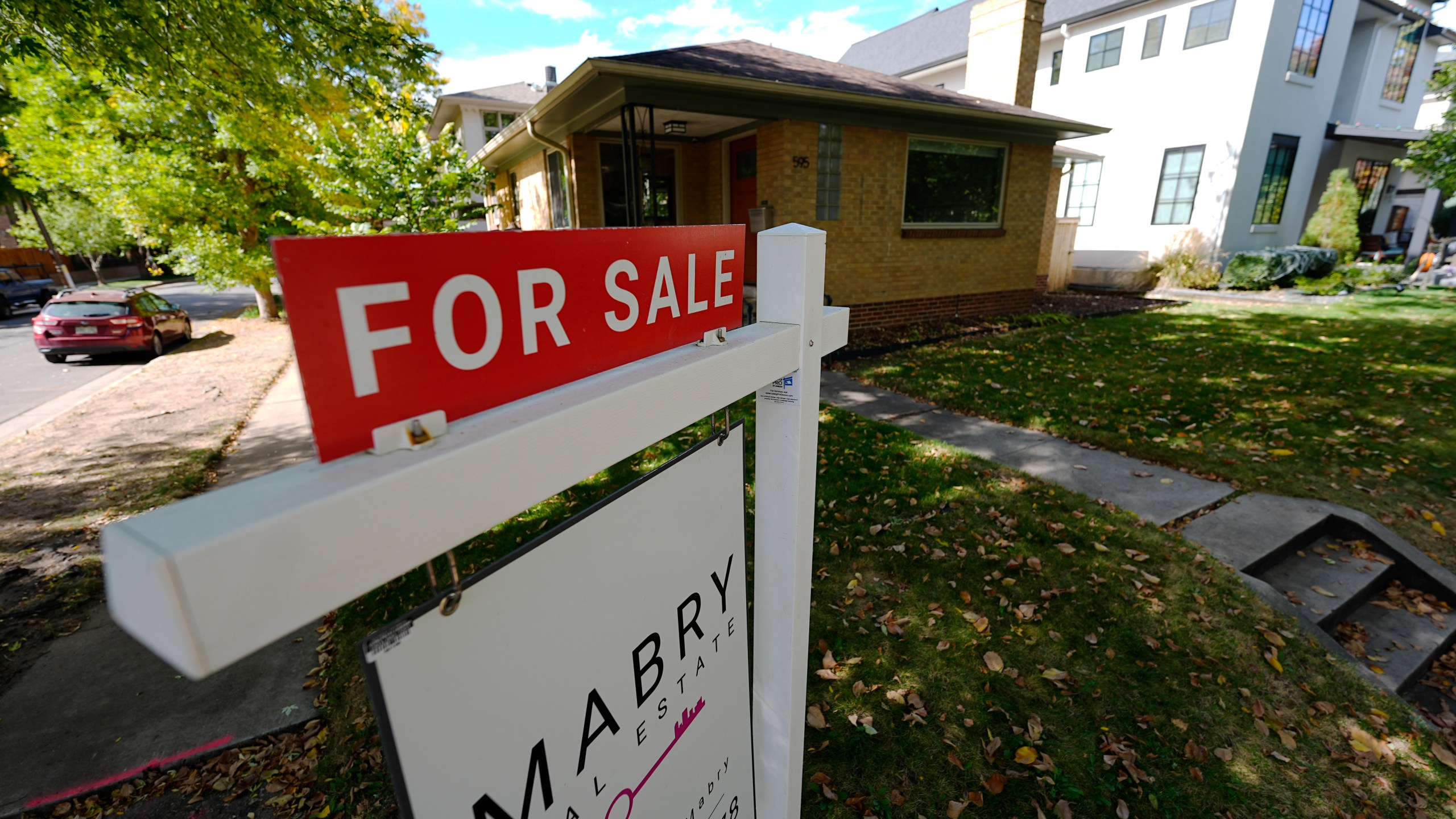 A sale sign stands outside a home on the market Thursday, Oct. 17, 2024, in the east Washington Park neighborhood of Denver. (AP Photo/David Zalubowski)