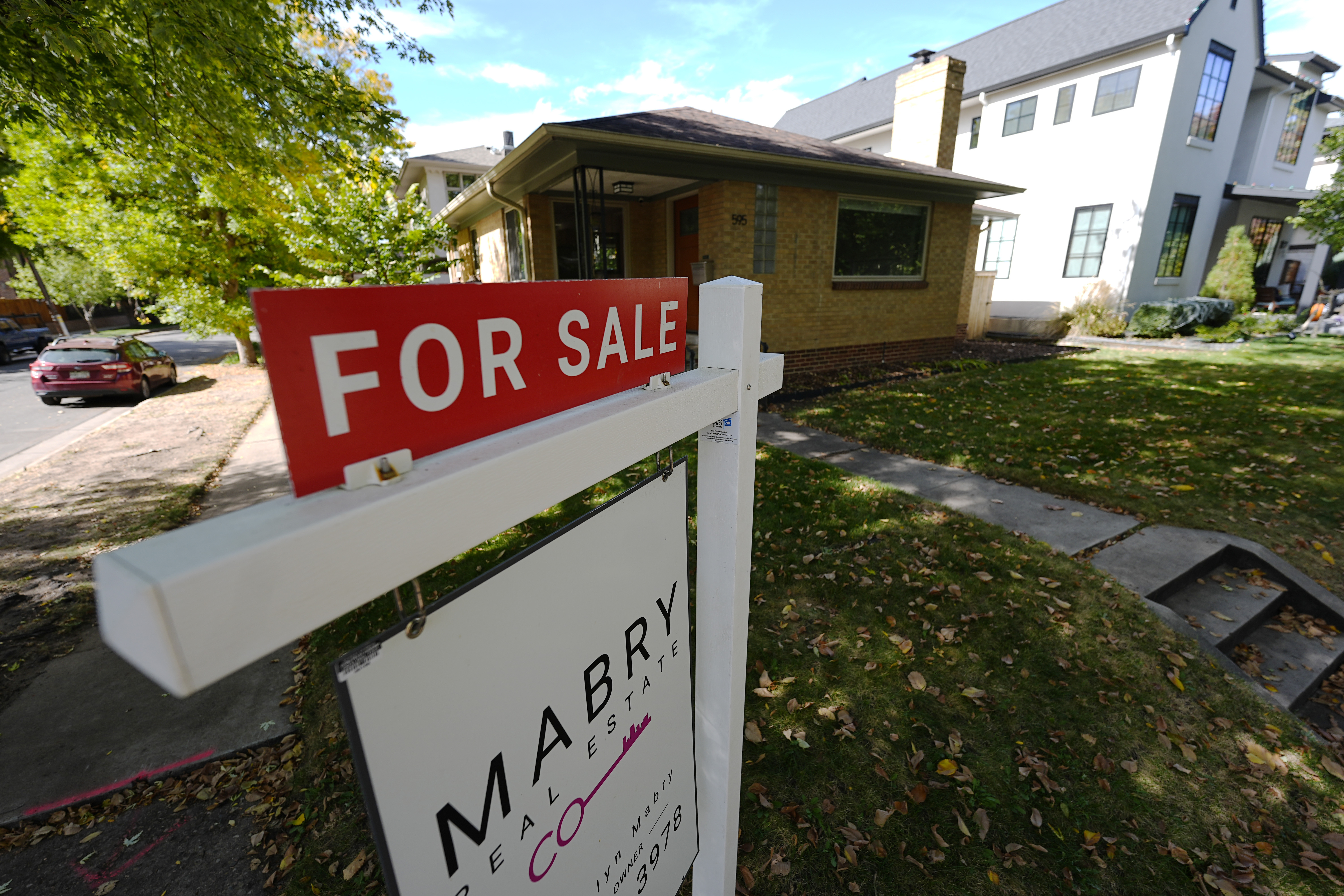 A sale sign stands outside a home on the market Thursday, Oct. 17, 2024, in the east Washington Park neighborhood of Denver. (AP Photo/David Zalubowski)