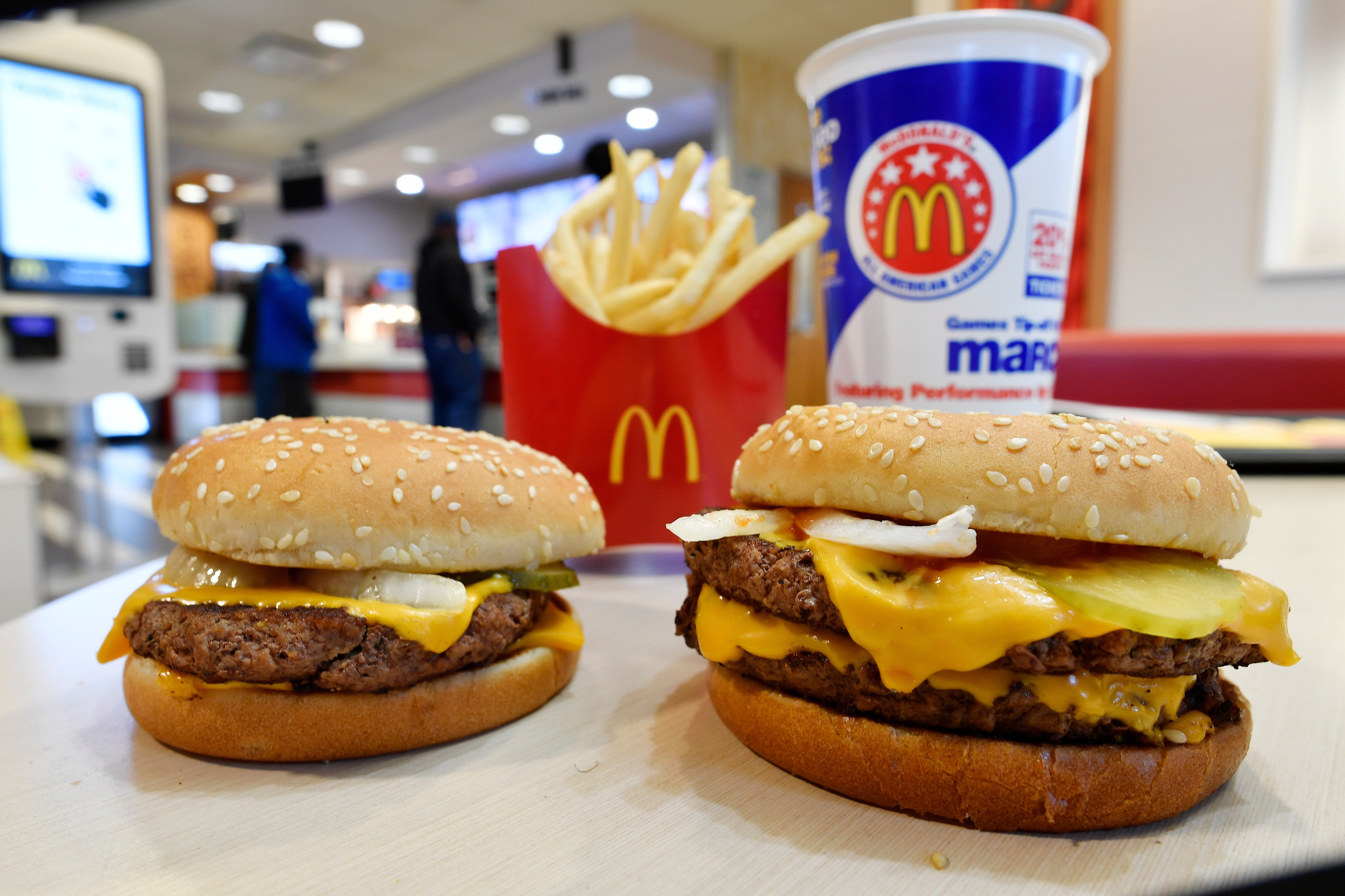 FILE- In this March 6, 2018, file photo, a McDonald's Quarter Pounder, left, and Double Quarter Pound burger is shown in Atlanta. (AP Photo/Mike Stewart, File)