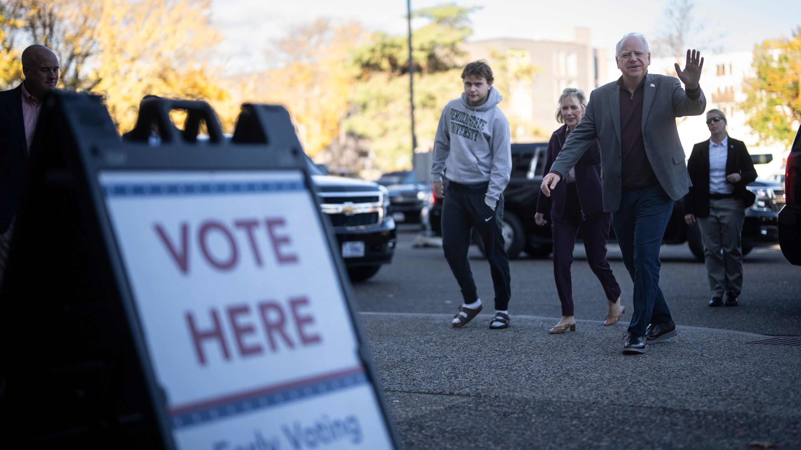 Minnesota Governor and Vice Presidential candidate Tim Walz enters the Ramsey County Elections office with his wife, Gwen, and son, Gus, to early vote in St. Paul, Minn., on Wednesday, October 23, 2024. (Renée Jones Schneider/Star Tribune via AP)