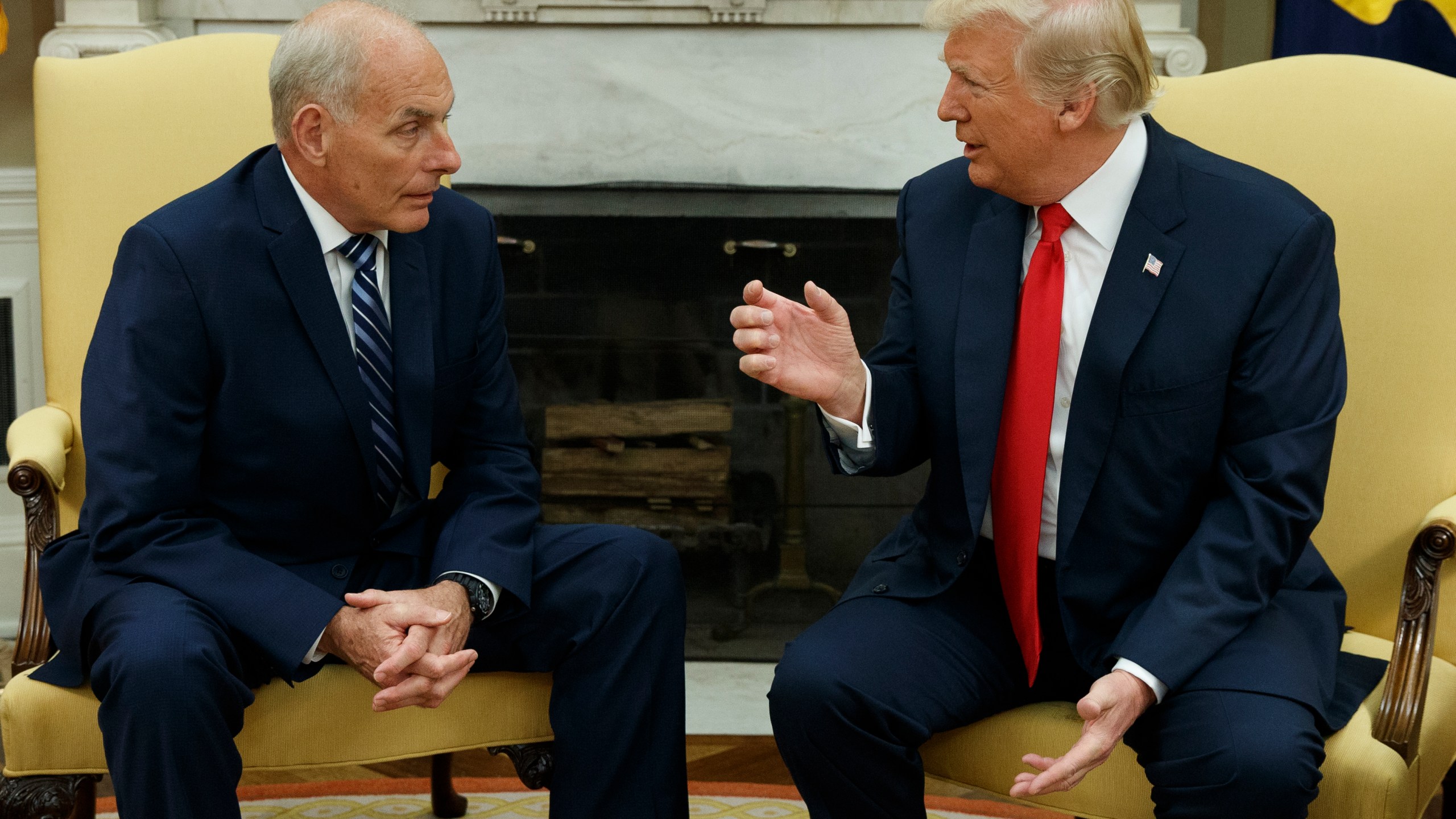 FILE - President Donald Trump talks with White House Chief of Staff John Kelly after he was privately sworn in during a ceremony in the Oval Office in Washington, July 31, 2017. (AP Photo/Evan Vucci, File)