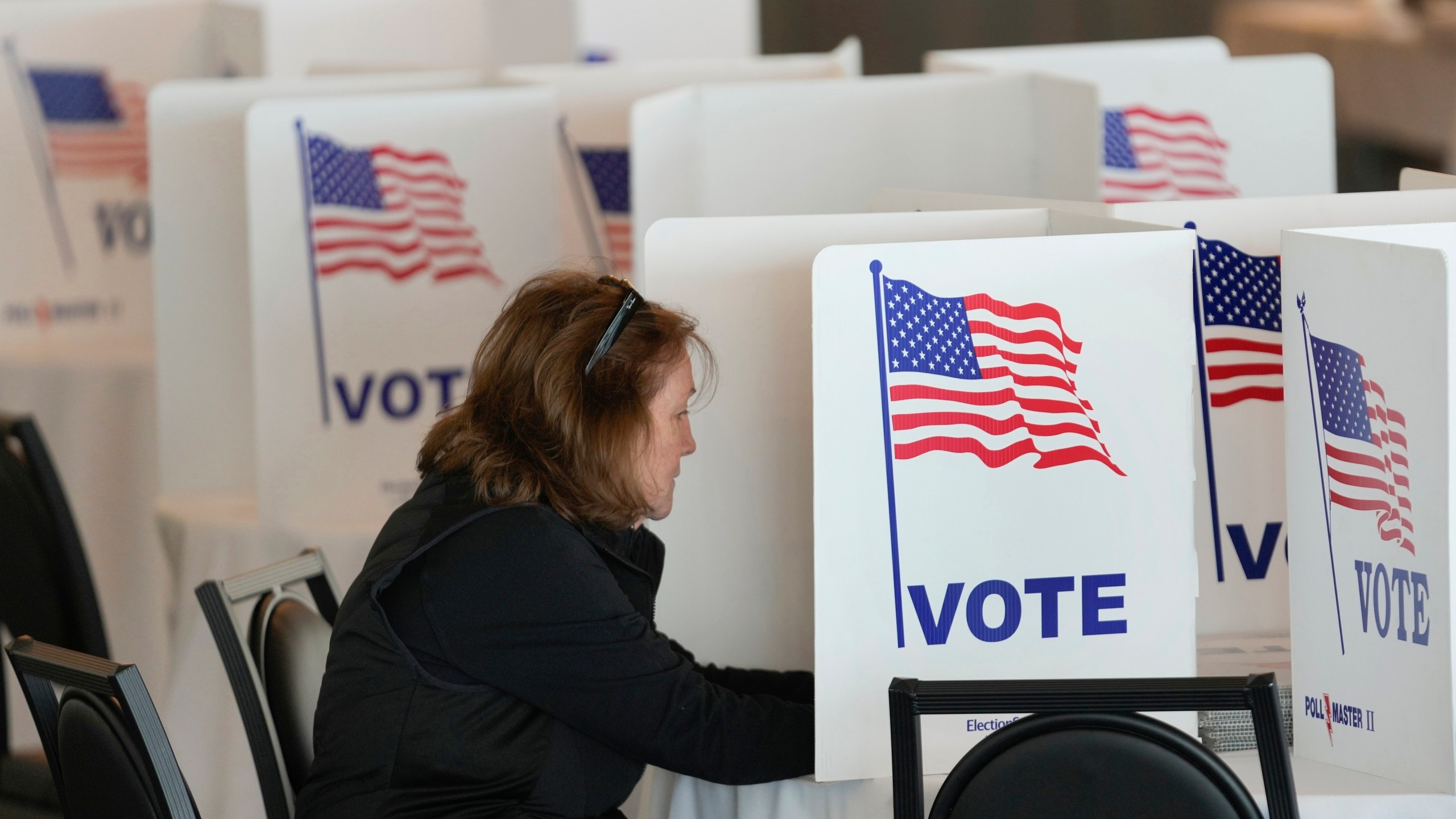 FILE - A voter fills out her ballot for the Michigan primary election in Grosse Pointe Farms, Mich., Tuesday, Feb. 27, 2024. (AP Photo/Paul Sancya, File)