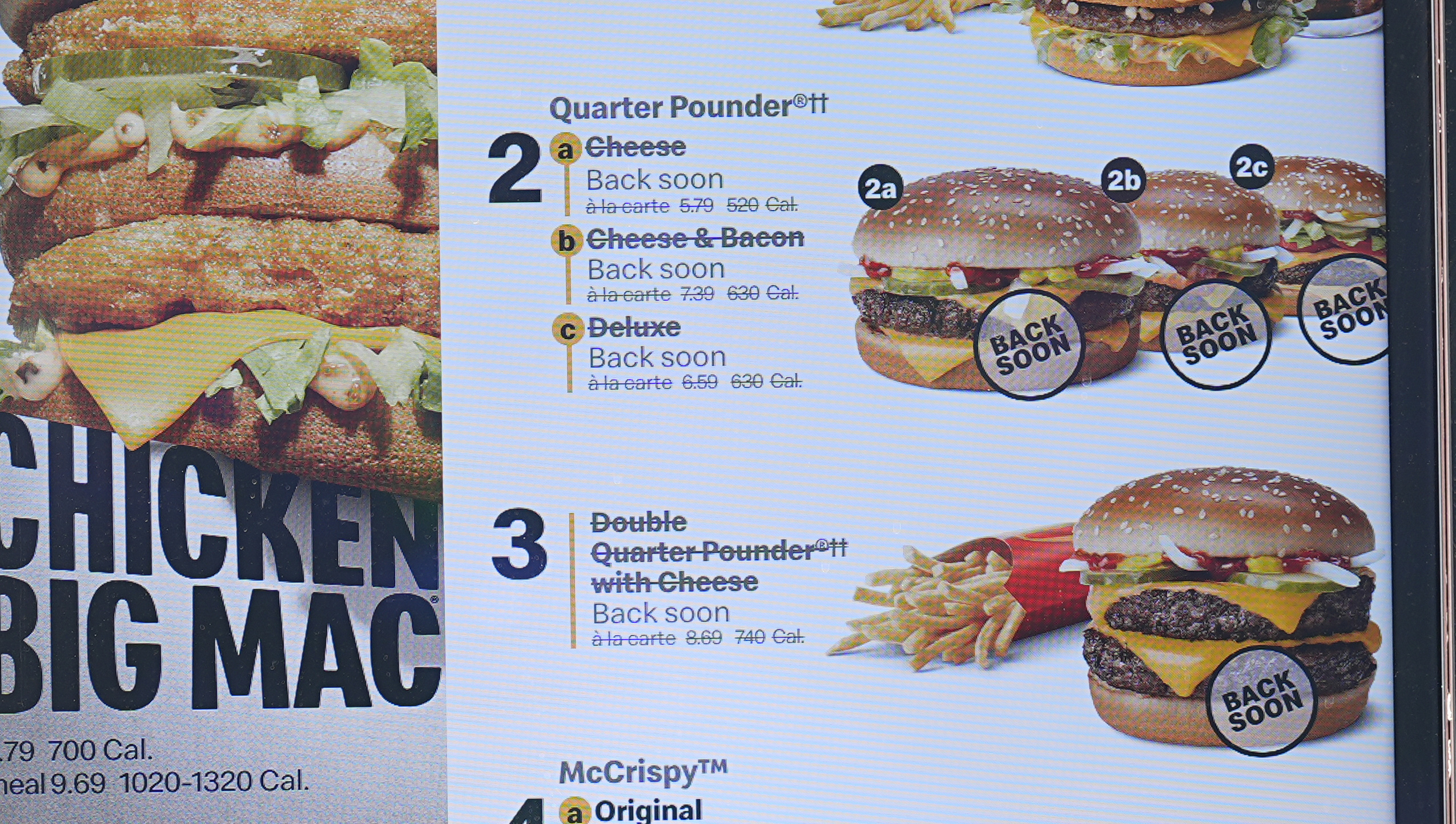 The electronic menu order board still displays Quarter Pounder hamburgers but with a prompt to tell consumers they will be available soon at a McDonald's drive-thru Wednesday, Oct. 23, 2024, in Littleton, Colo. (AP Photo/David Zalubowski)