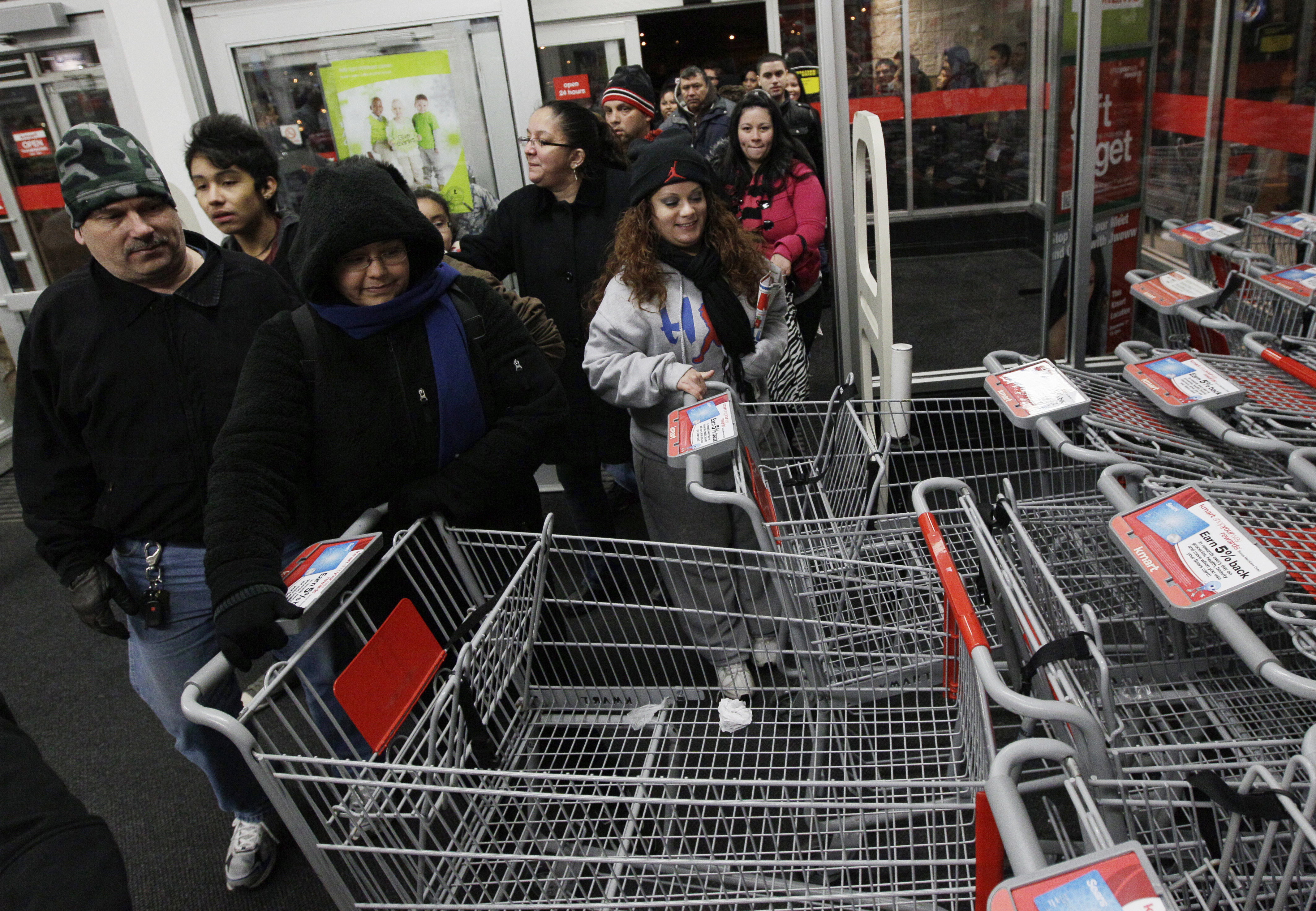 FILE - Shoppers rush into a Kmart store in Chicago on on Nov. 25, 2011 for Black Friday sale. (AP Photo/Nam Y. Huh, File)