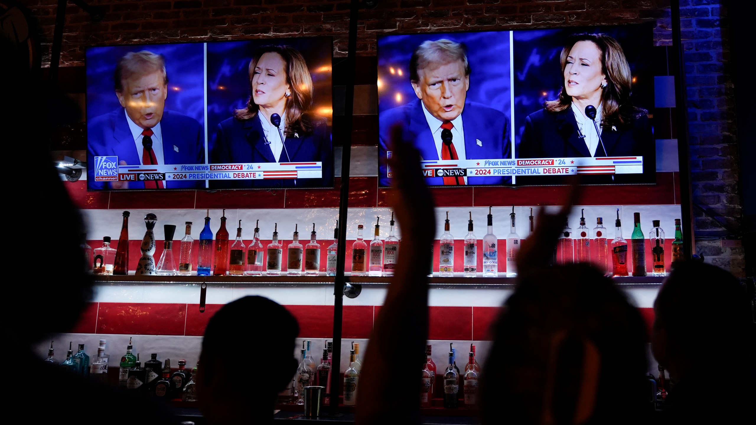 FILE - Viewers cheer as they watch a debate between Democratic presidential nominee Vice President Kamala Harris and Republican presidential nominee former President Donald Trump at the Angry Elephant Bar and Grill, Sept. 10, 2024, in San Antonio. (AP Photo/Eric Gay, File)