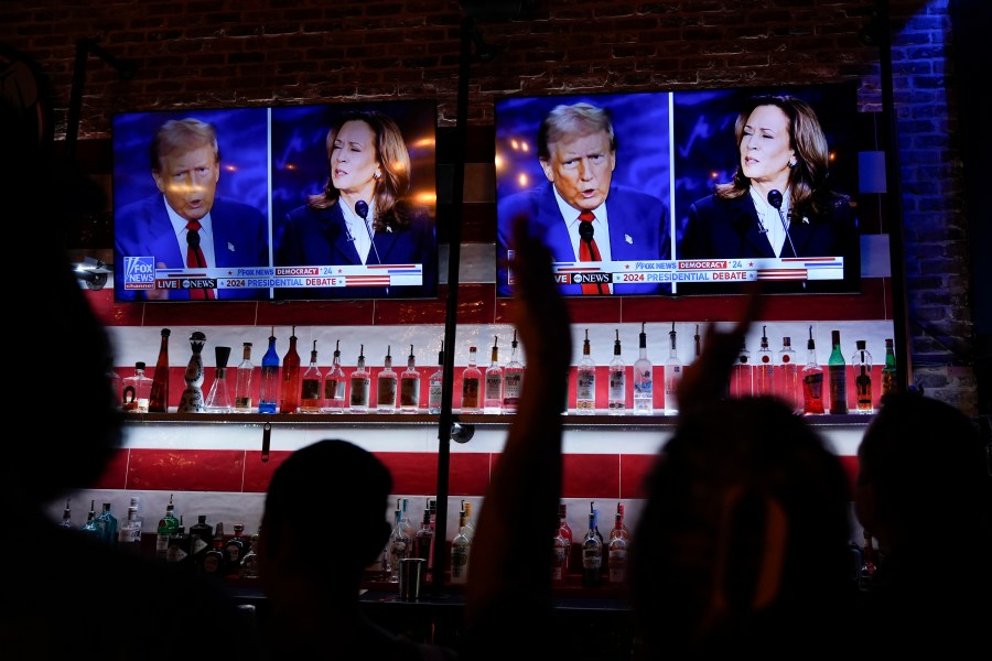 FILE - Viewers cheer as they watch a debate between Democratic presidential nominee Vice President Kamala Harris and Republican presidential nominee former President Donald Trump at the Angry Elephant Bar and Grill, Sept. 10, 2024, in San Antonio. (AP Photo/Eric Gay, File)