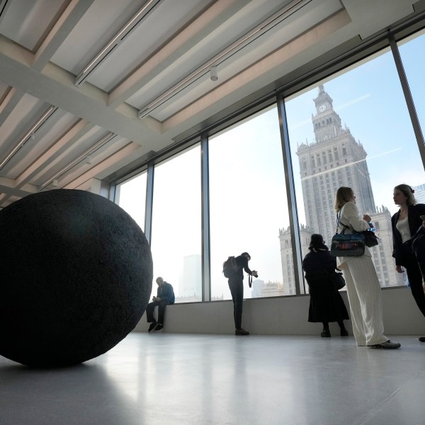 People look out of the window of the Museum of Modern Art in Warsaw, Poland, on Thursday Oct. 24, 2024. (AP Photo/Czarek Sokolowski)