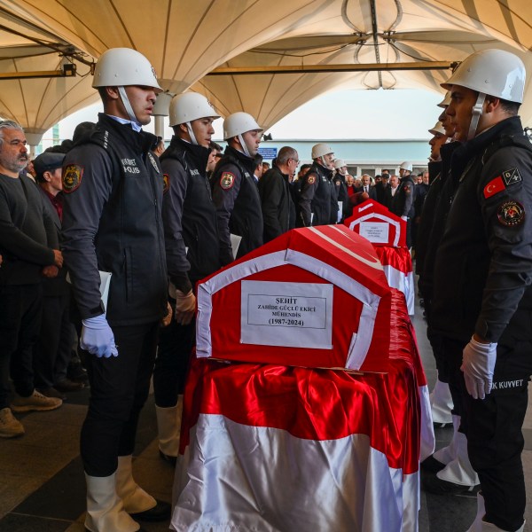 Turkish soldiers stand next to the coffins of Zahide Guglu Ekici, Hasan Huseyin Canbaz and Cengiz Coskun during their funeral at Karsiyaka mosque in Ankara, Thursday, Oct. 24, 2024, a day after they were killed during an attack by PKK members at the Turkish aerospace and defense company TUSAS on Wednesday. (AP Photo/Ali Unal)