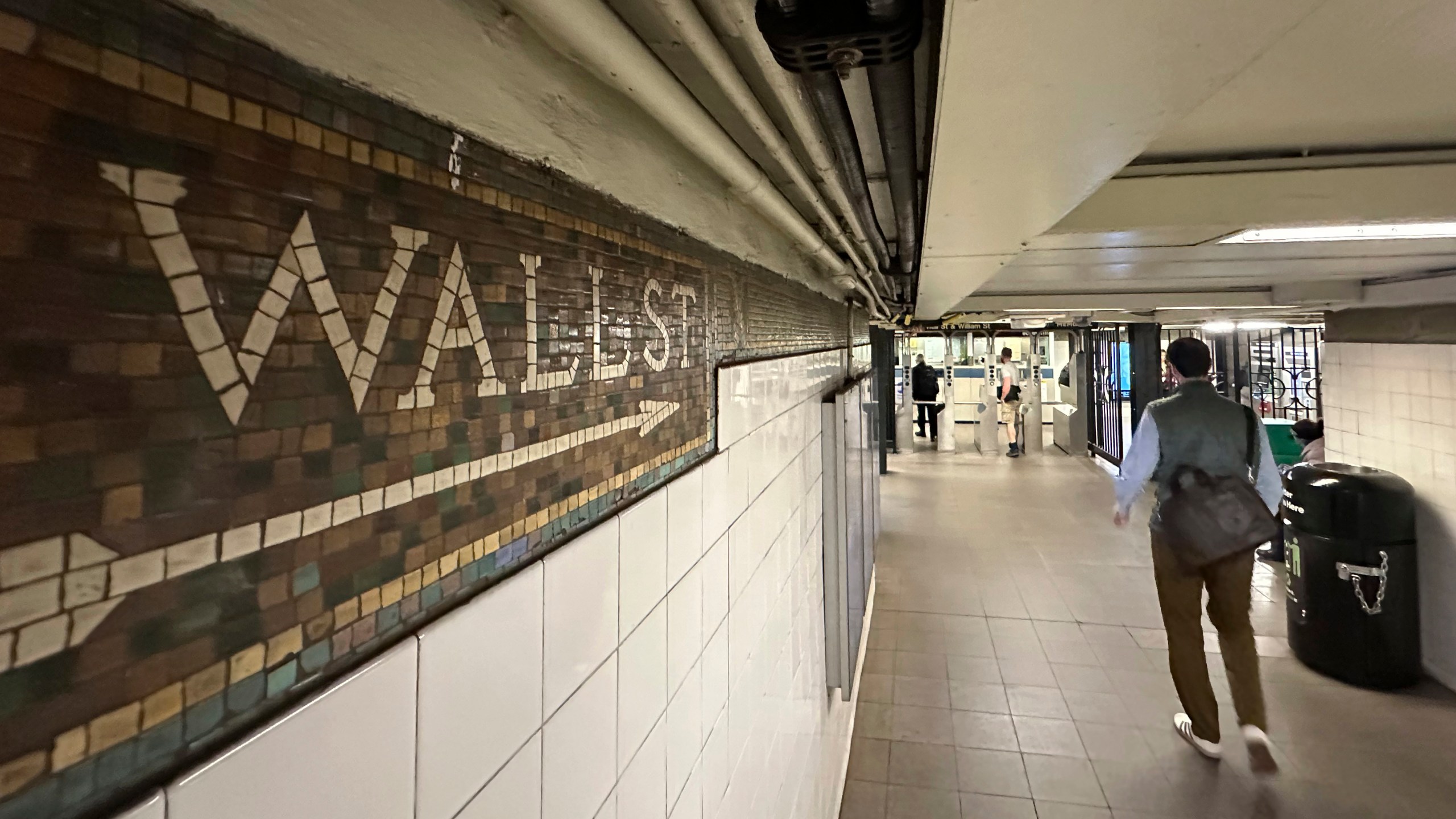 FILE - Commuters leave a Wall St. subway station in New York's Financial District on Oct. 23, 2024. (AP Photo/Peter Morgan, File)