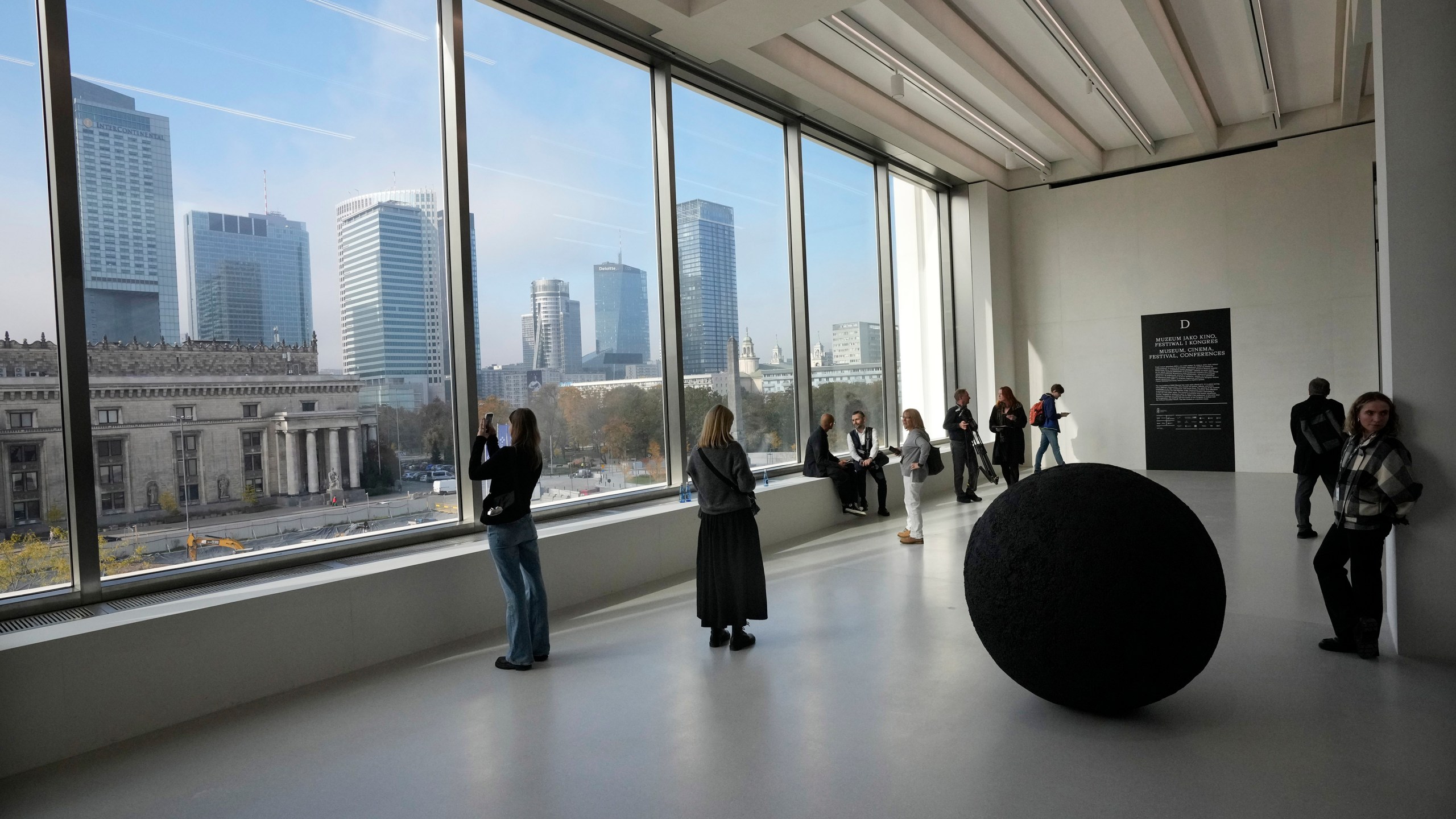 People look out of the window of the Museum of Modern Art in Warsaw, Poland, on Thursday Oct. 24, 2024. (AP Photo/Czarek Sokolowski)