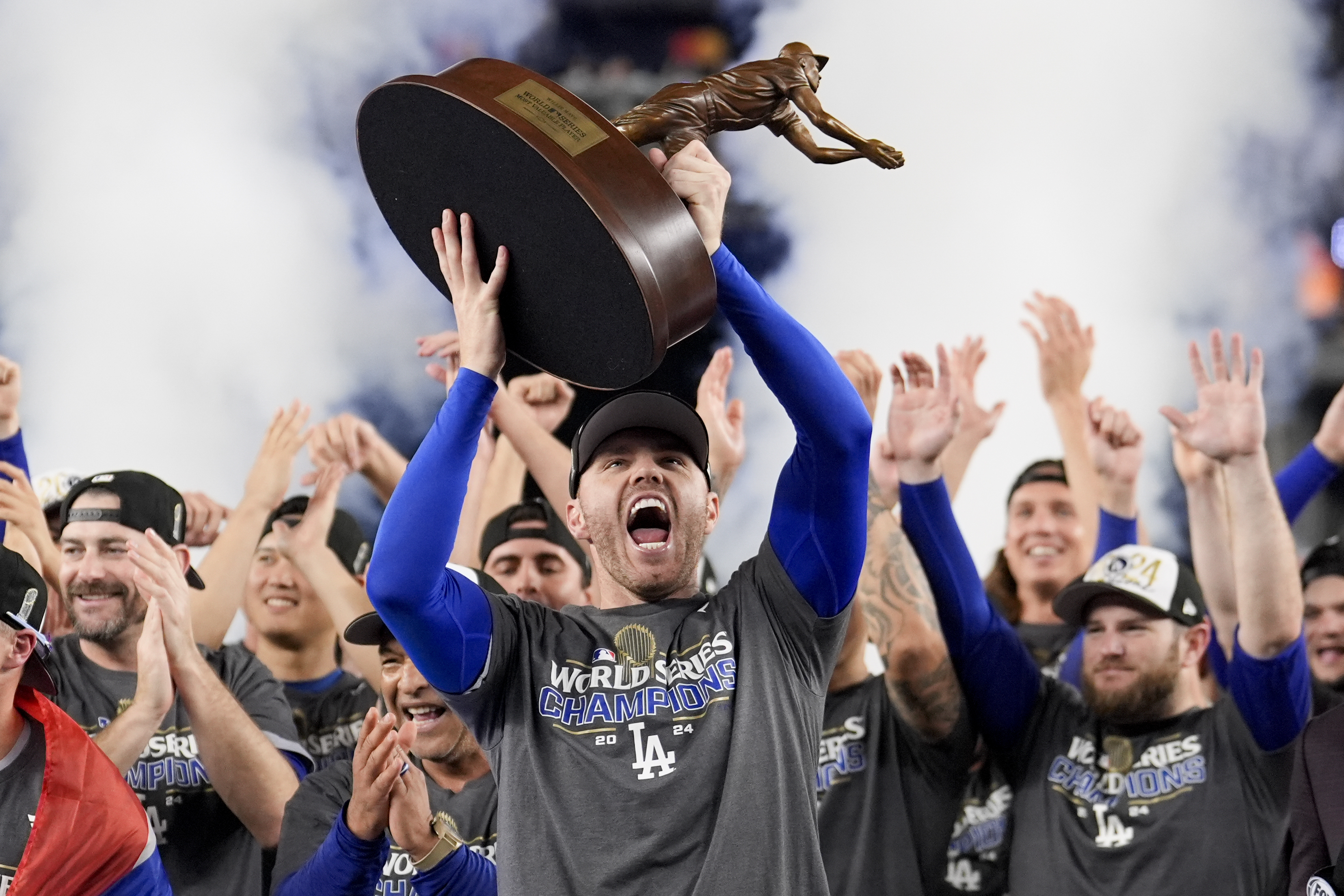 Los Angeles Dodgers' Freddie Freeman celebrates with the MVP trophy after their win against the New York Yankees in Game 5 to win the baseball World Series, Thursday, Oct. 31, 2024, in New York. (AP Photo/Ashley Landis)