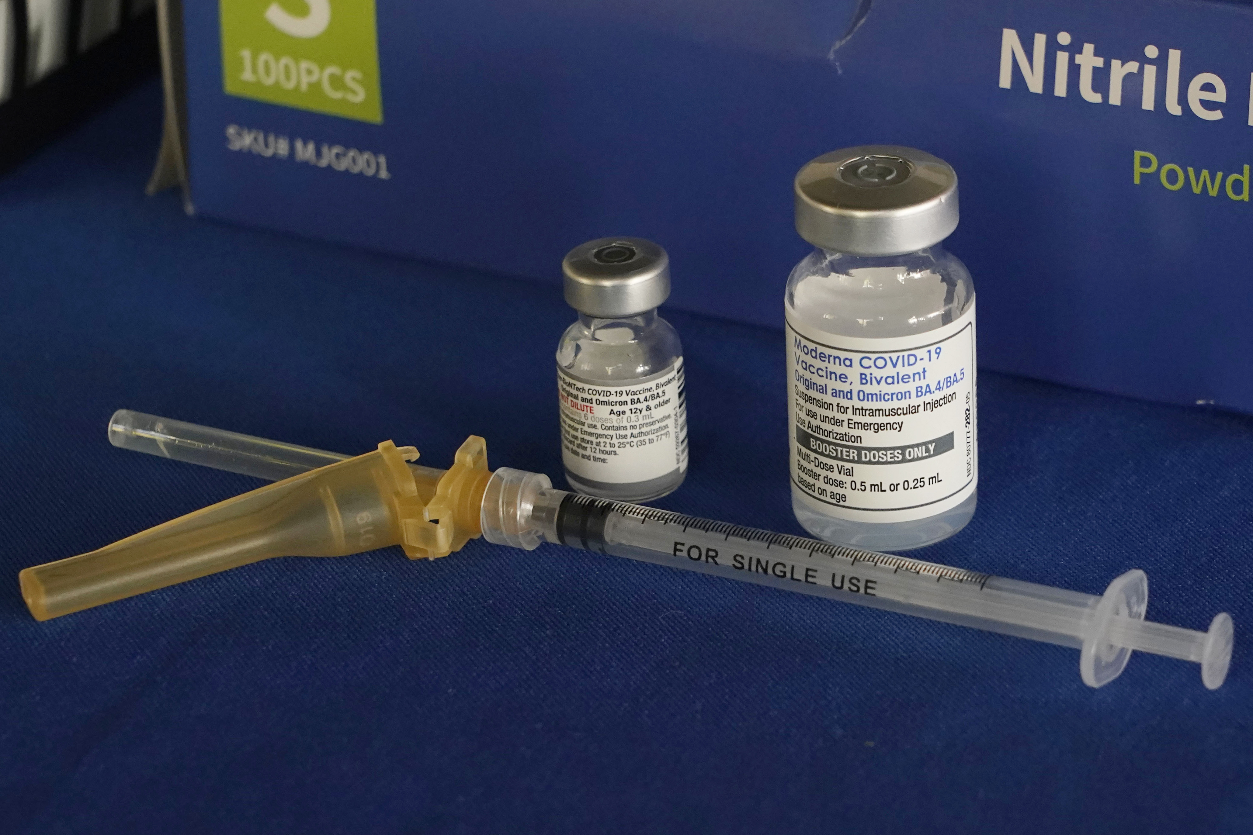 FILE - A syringe lies next to vials of COVID-19 booster vaccines at an inoculation station in Jackson, Miss., Friday, Nov. 18, 2022. (AP Photo/Rogelio V. Solis, File)