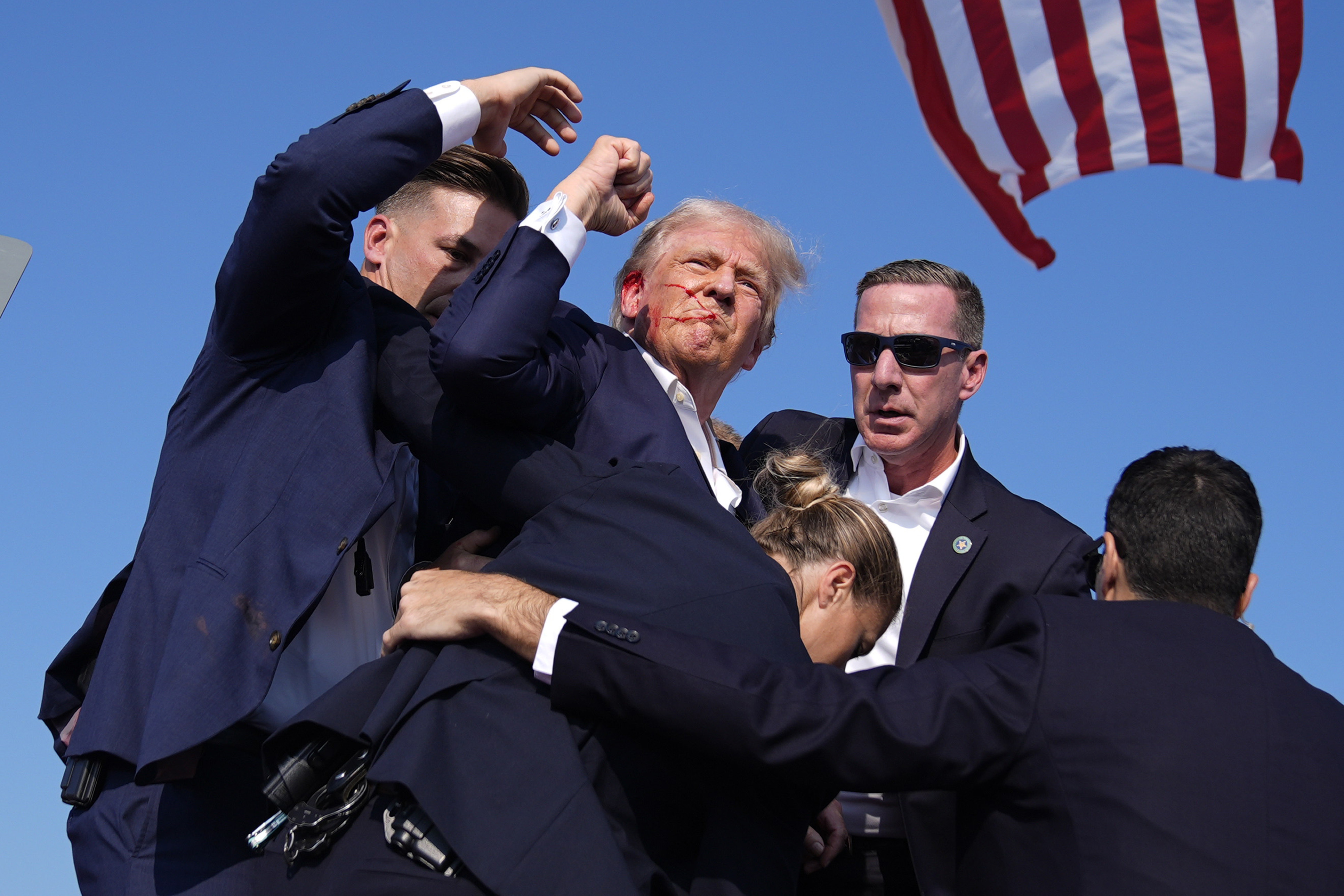 Republican presidential candidate former President Donald Trump is surrounded by U.S. Secret Service agents at a campaign rally, July 13, 2024, in Butler, Pa. (AP Photo/Evan Vucci, File)