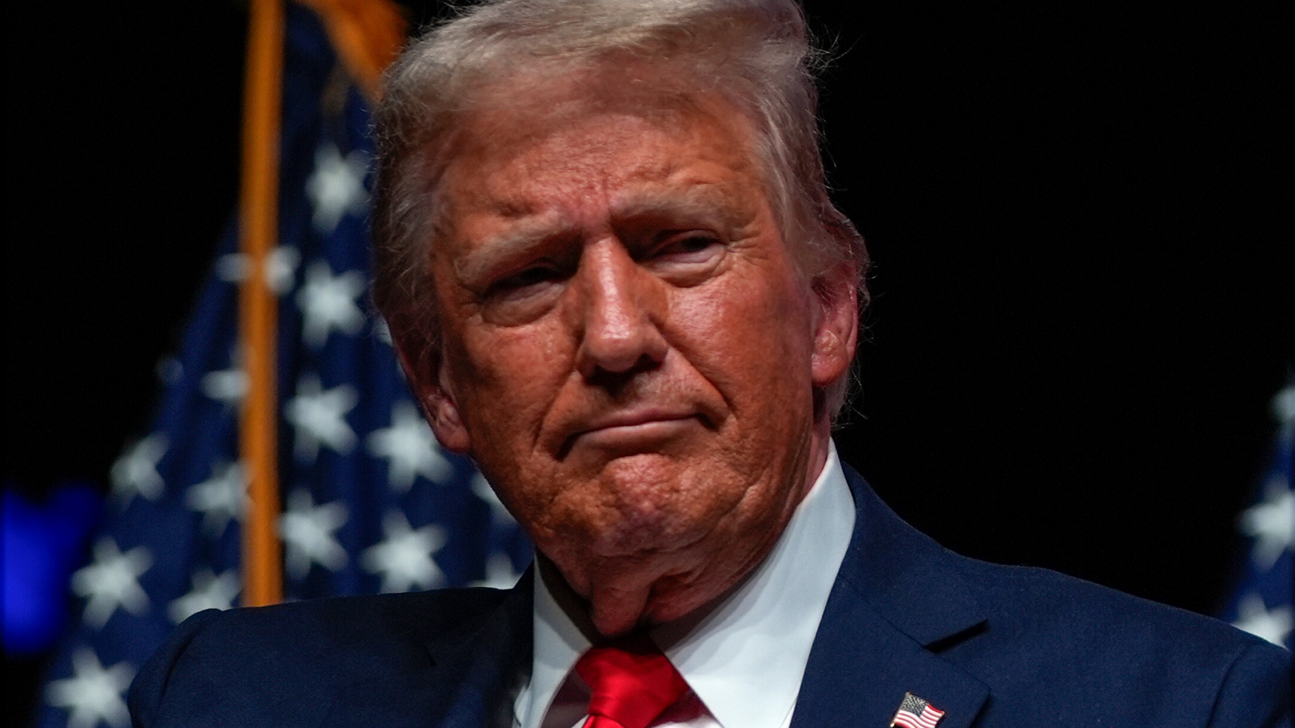 Republican presidential nominee former President Donald Trump listens during a Tucker Carlson Live Tour show at Desert Diamond Arena, Thursday, Oct. 31, 2024, in Glendale, Ariz. (AP Photo/Julia Demaree Nikhinson)