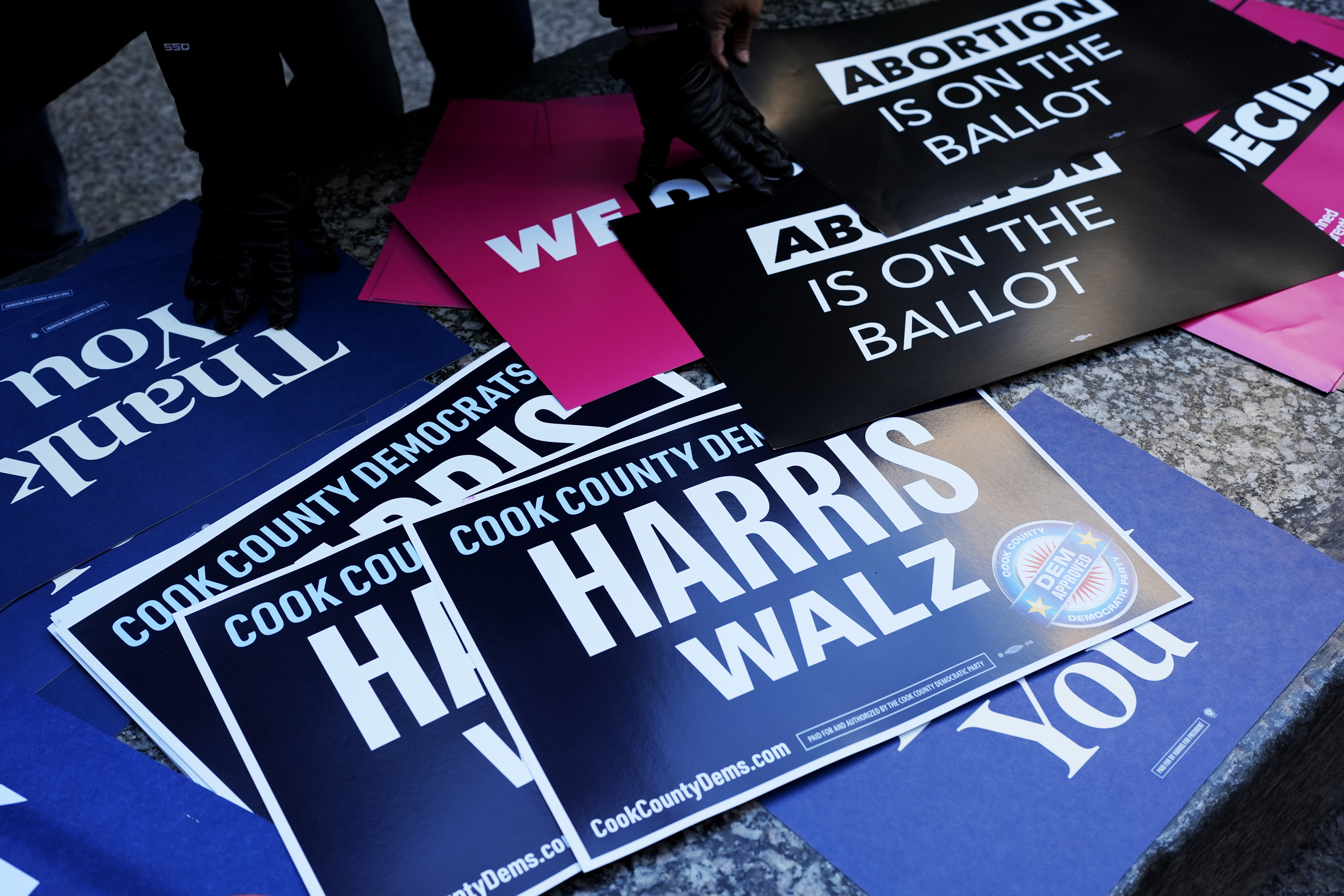 Signs are seen at National Women's March in Chicago, Saturday, Nov. 2, 2024. The Women's March movement launched the day after Donald Trump's inauguration, when hundreds of thousands of women poured into the District and across the country in what is widely considered the largest single-day protest in American history. (AP Photo/Nam Y. Huh)