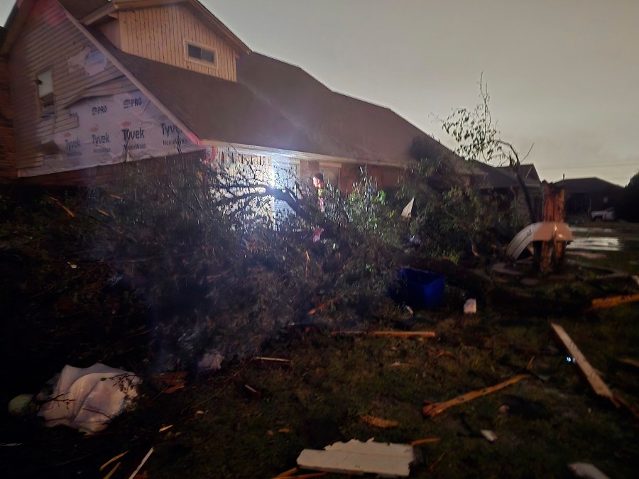 This image provided by Sean Taylor shows a person entering a damaged home after a tornado hit the area in Midwest City, Okla,, Sunday, Nov. 3, 2024. (Sean Taylor via AP)