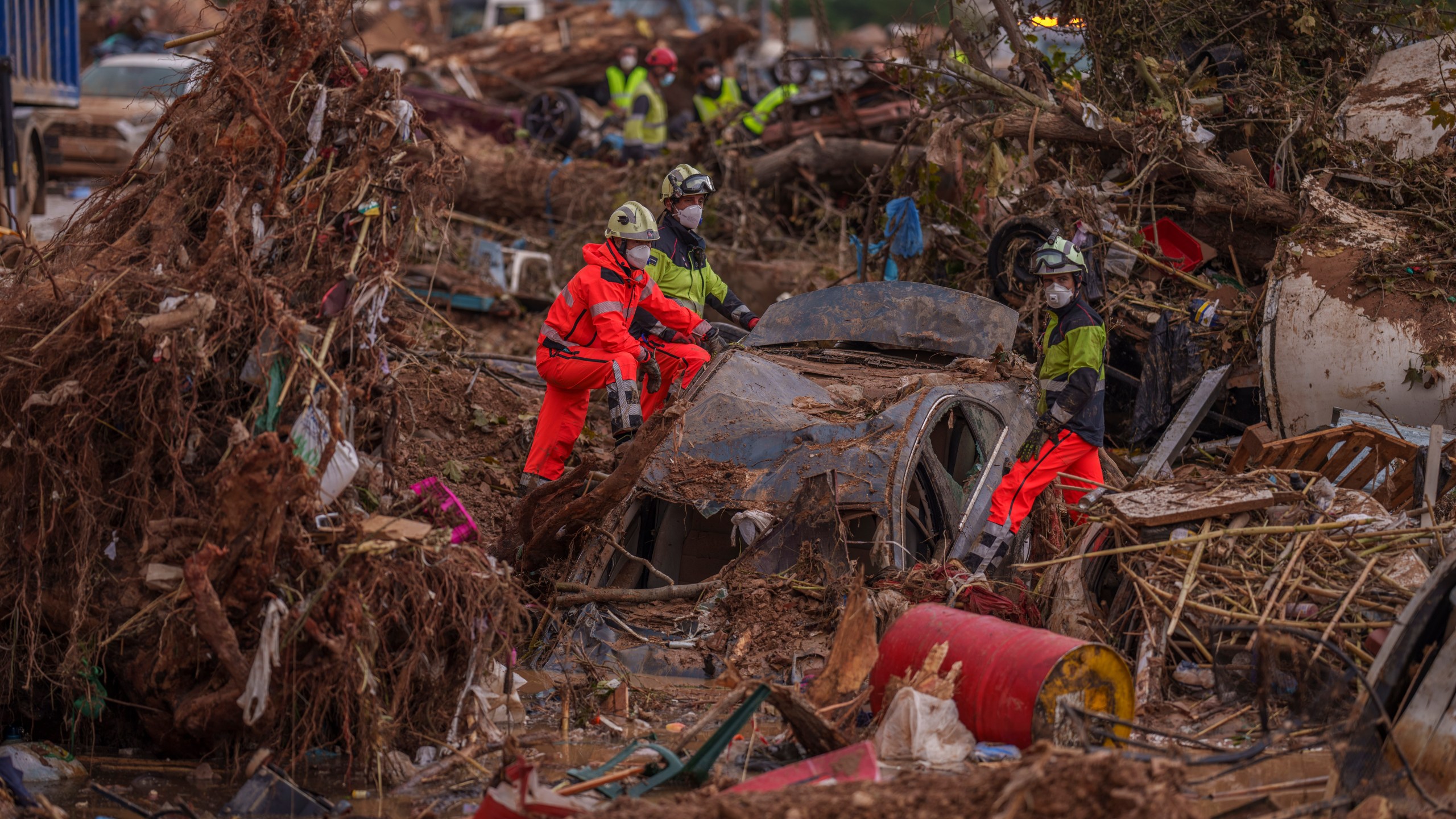 Emergency services remove cars in an area affected by floods in Catarroja, Spain, on Sunday, Nov. 3, 2024. (AP Photo/Manu Fernandez)