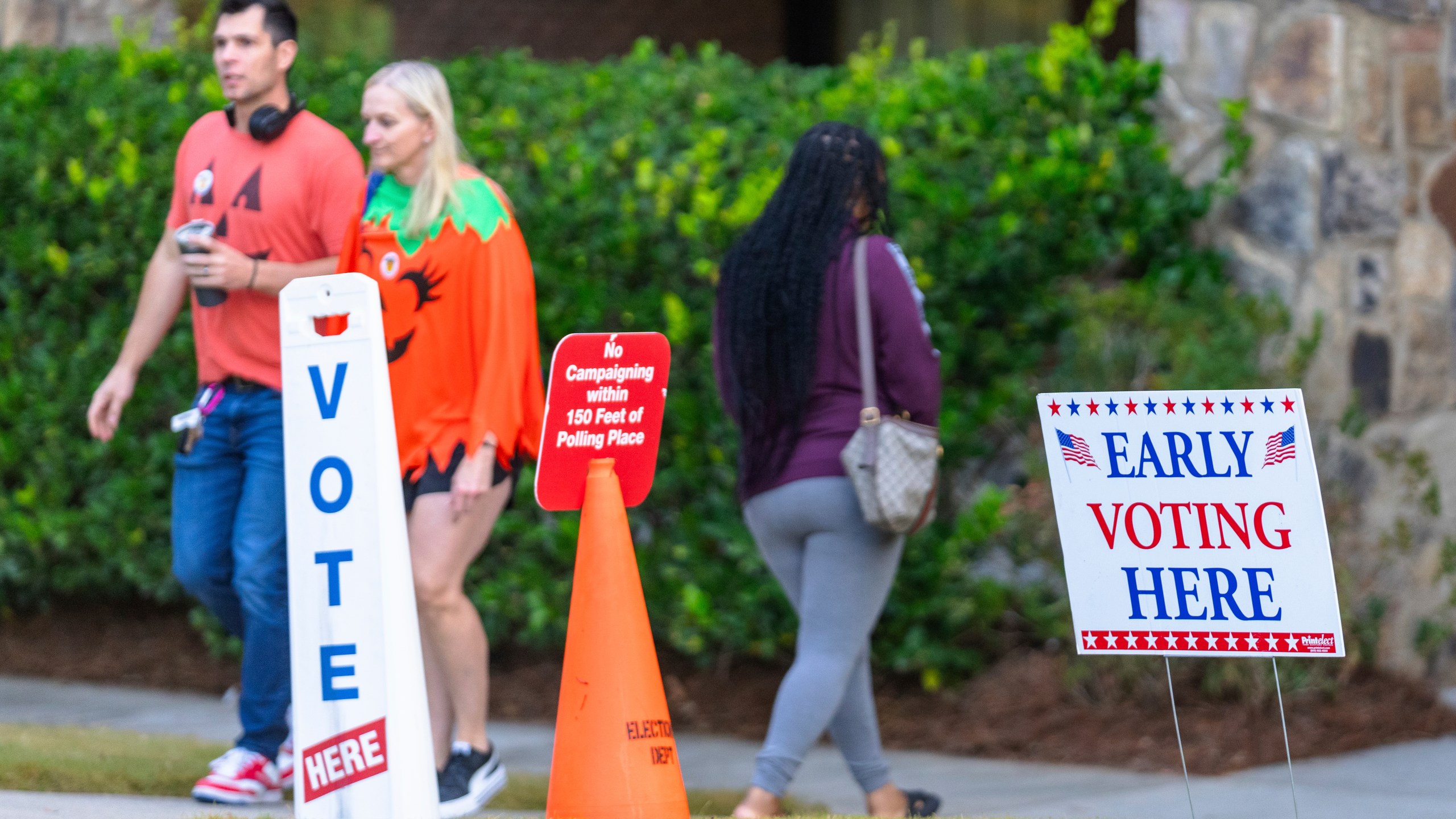 FILE - An Early Voting sign and a "No Campaigning within 150 feet of Polling Place" sign seen the polling station, Oct. 31, 2024, in Stockbridge, Ga. (AP Photo/Jason Allen, File)