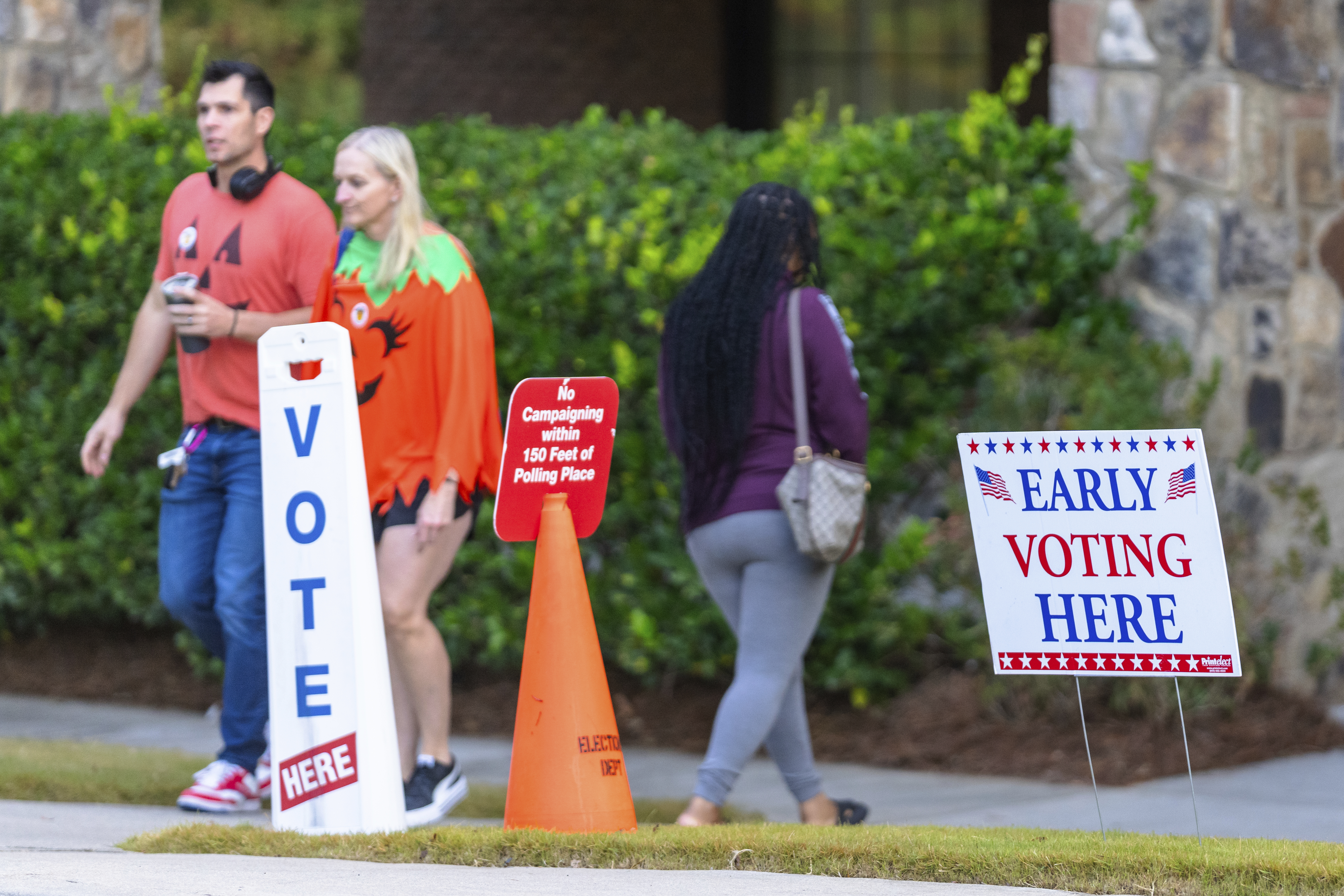 FILE - An Early Voting sign and a "No Campaigning within 150 feet of Polling Place" sign seen the polling station, Oct. 31, 2024, in Stockbridge, Ga. (AP Photo/Jason Allen, File)