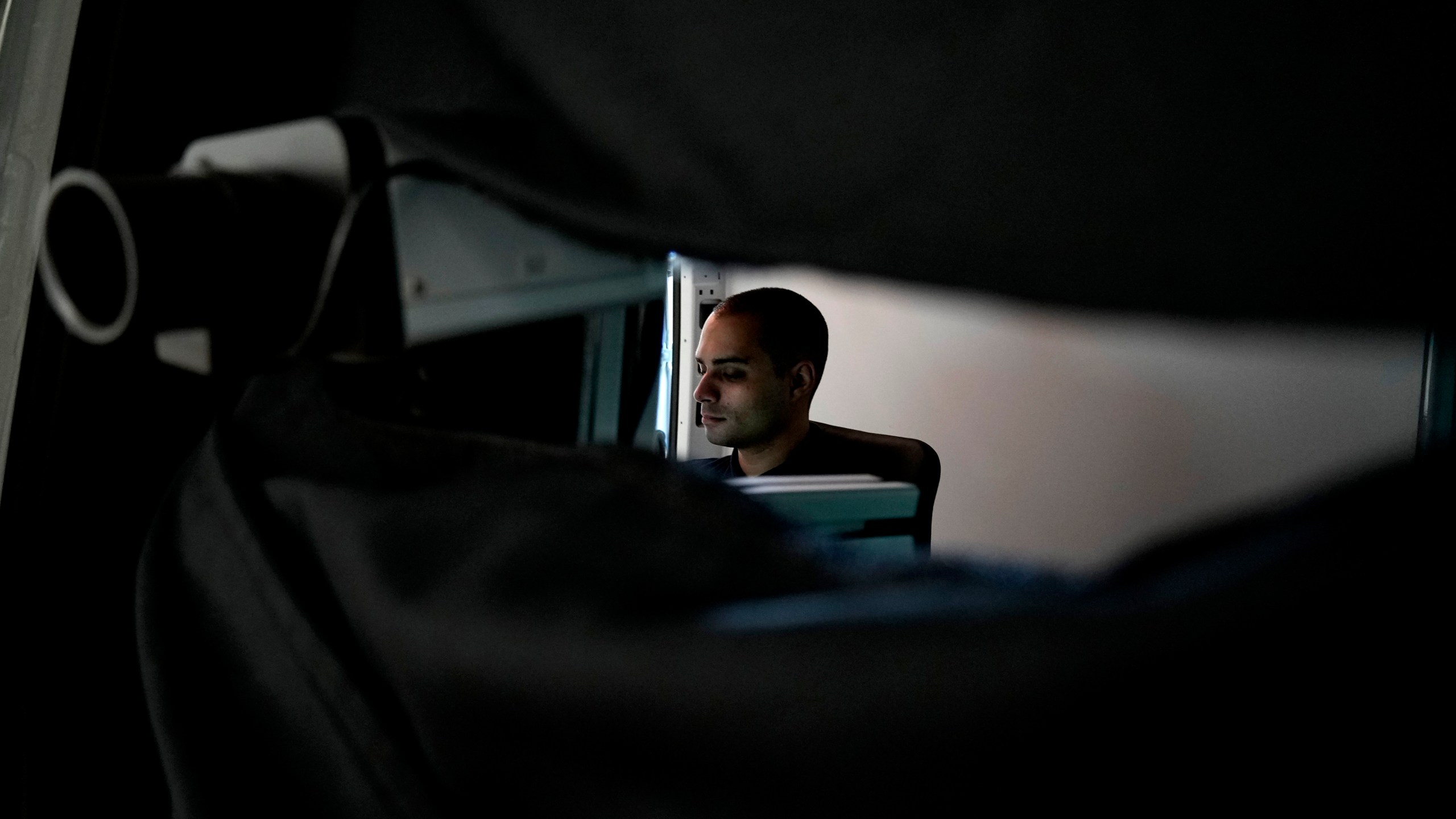 Charalambos Madritis sits in front of a computer laptop inside a specially configured van equipped with highly sensitive sensors able to detect radioactive materials, parked inside the U.S.-funded Cyprus Center for Land, Open Seas and Port Security (CYCLOPS) in Larnaca, Cyprus, on Monday, Nov. 4, 2024. (AP Photo/Petros Karadjias)