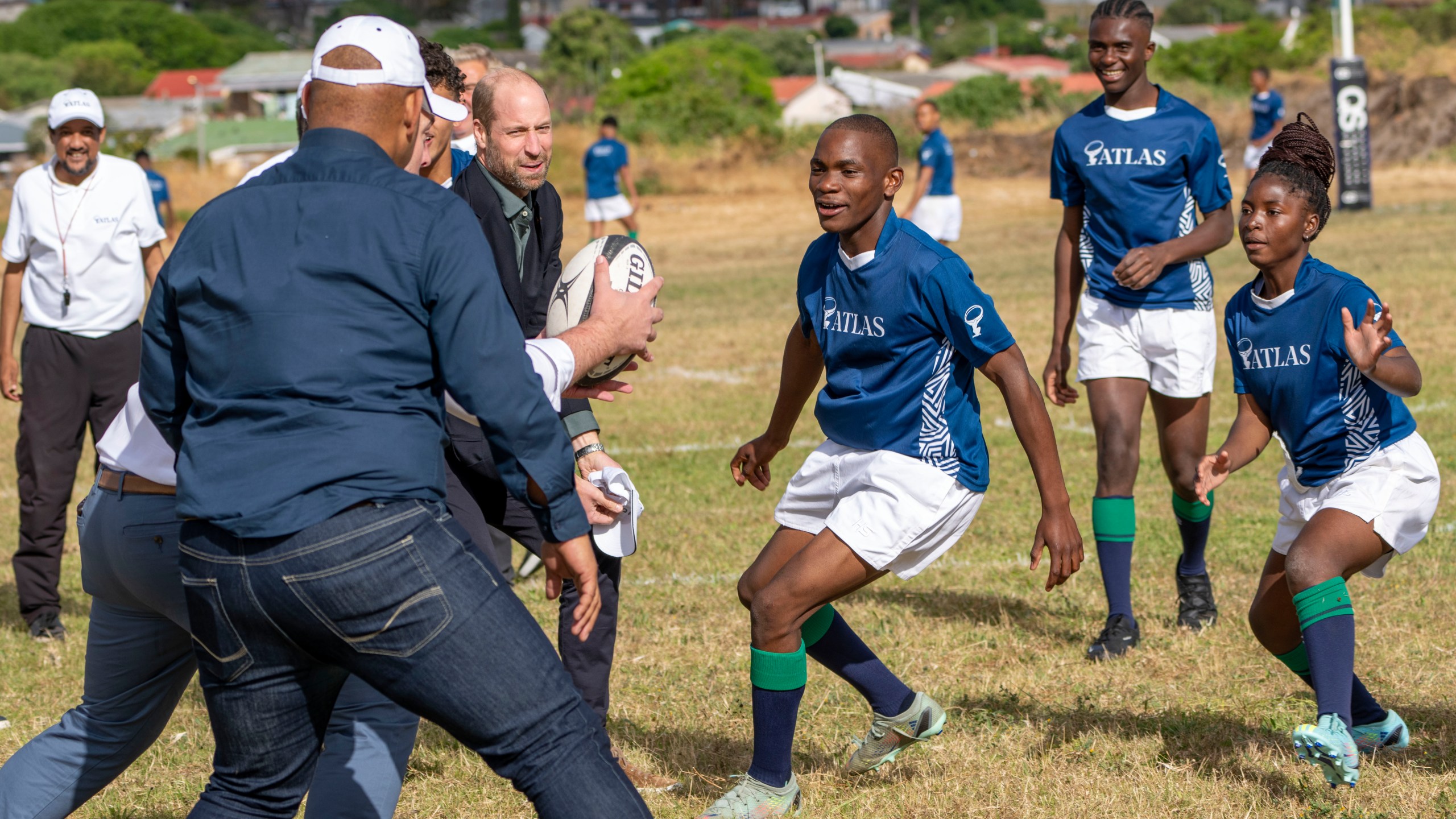 Britain's Prince William plays rugby with pupils at the Ocean View Secondary School in Cape Town, South Africa, Monday, Nov. 4, 2024. (AP Photo/Jerome Delay-pool)