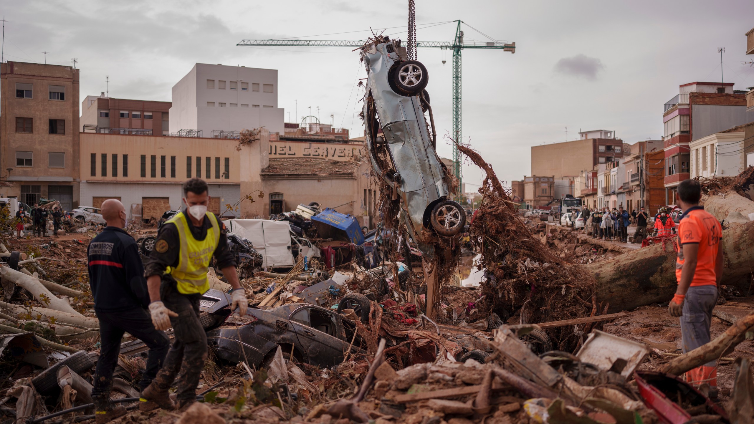 Emergency services remove cars in an area affected by floods in Catarroja, Spain, on Sunday, Nov. 3, 2024. (AP Photo/Manu Fernandez)