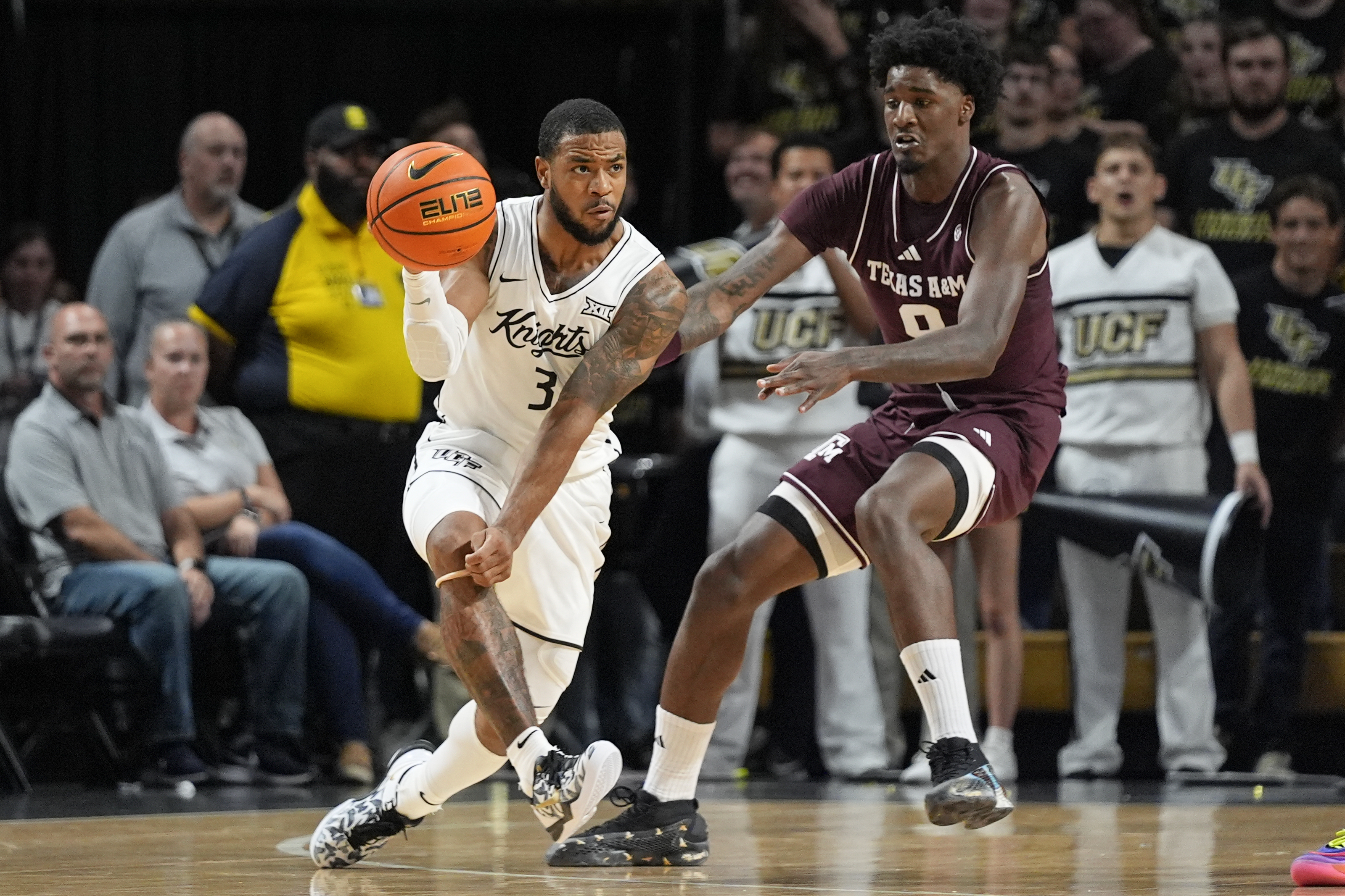 Central Florida guard Darius Johnson (3) passes the ball as he is defended by Texas A&M forward Solomon Washington, right, during the first half of an NCAA college basketball game, Monday, Nov. 4, 2024, in Orlando, Fla. (AP Photo/John Raoux)