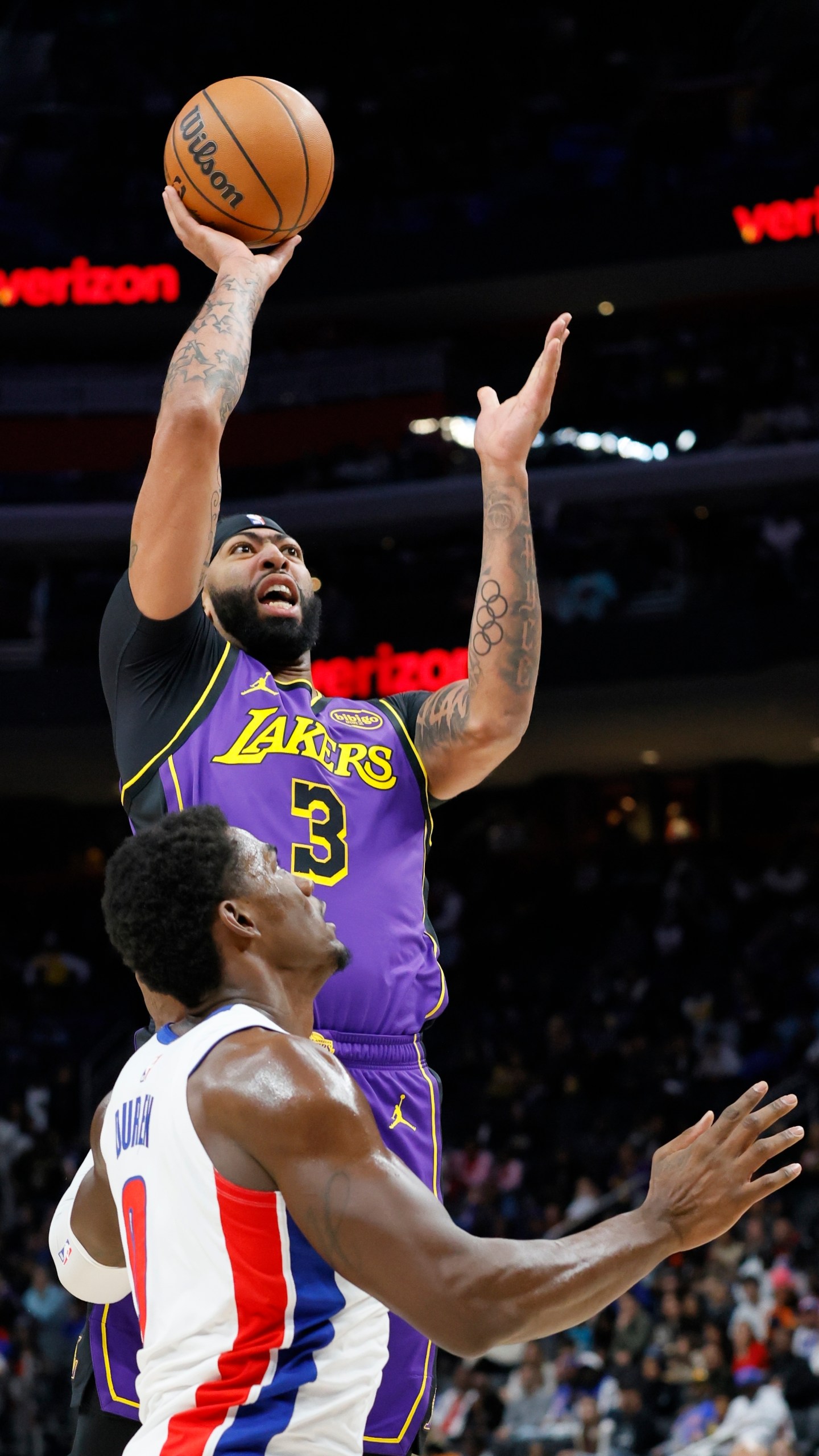 Los Angeles Lakers forward Anthony Davis (3) shoots over Detroit Pistons center Jalen Duren (0) during the first half of an NBA basketball game Monday, Nov. 4, 2024, in Detroit. (AP Photo/Duane Burleson)