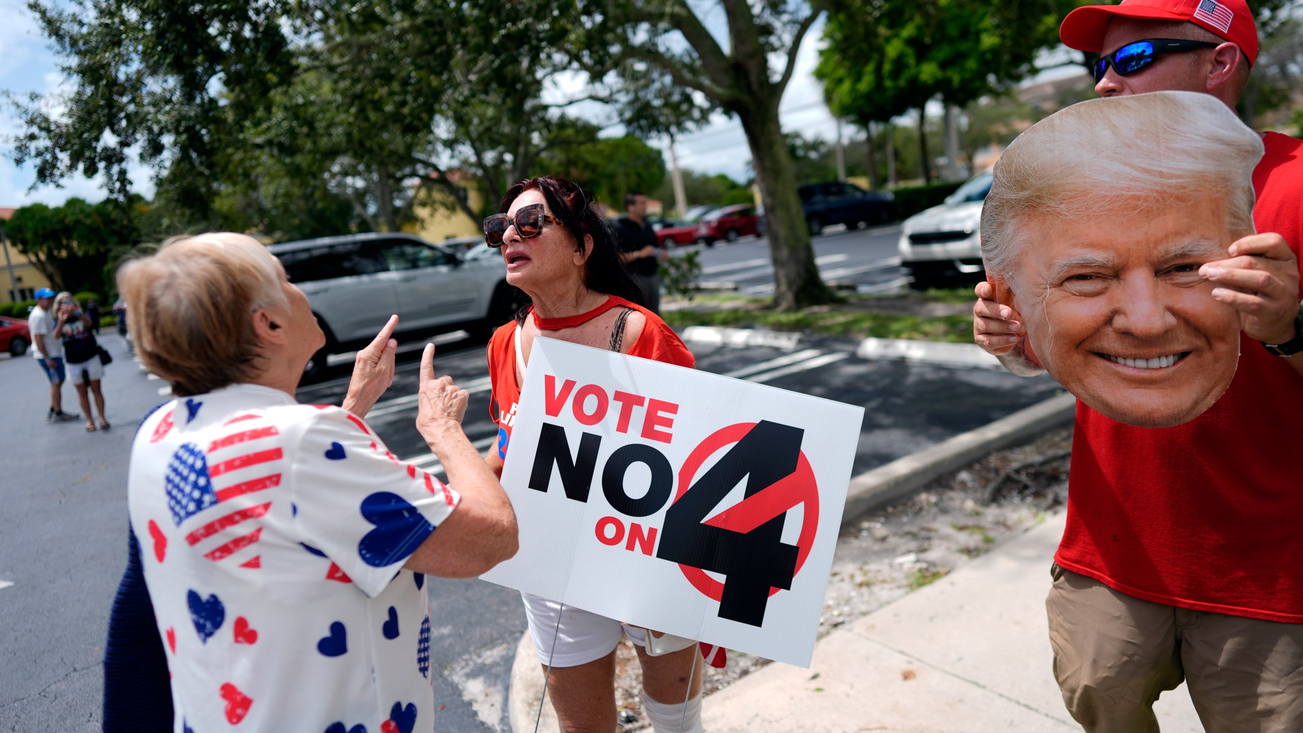 FILE - A supporter of Democratic presidential nominee Vice President Kamala Harris, left, argues about abortion rights with supporters of Republican presidential nominee former President Donald Trump, protesting alongside an event kicking off a national "Reproductive Freedom Bus Tour" by the Harris-Walz campaign, Tuesday, Sept. 3, 2024, in Boynton Beach, Fla. (AP Photo/Rebecca Blackwell,File)