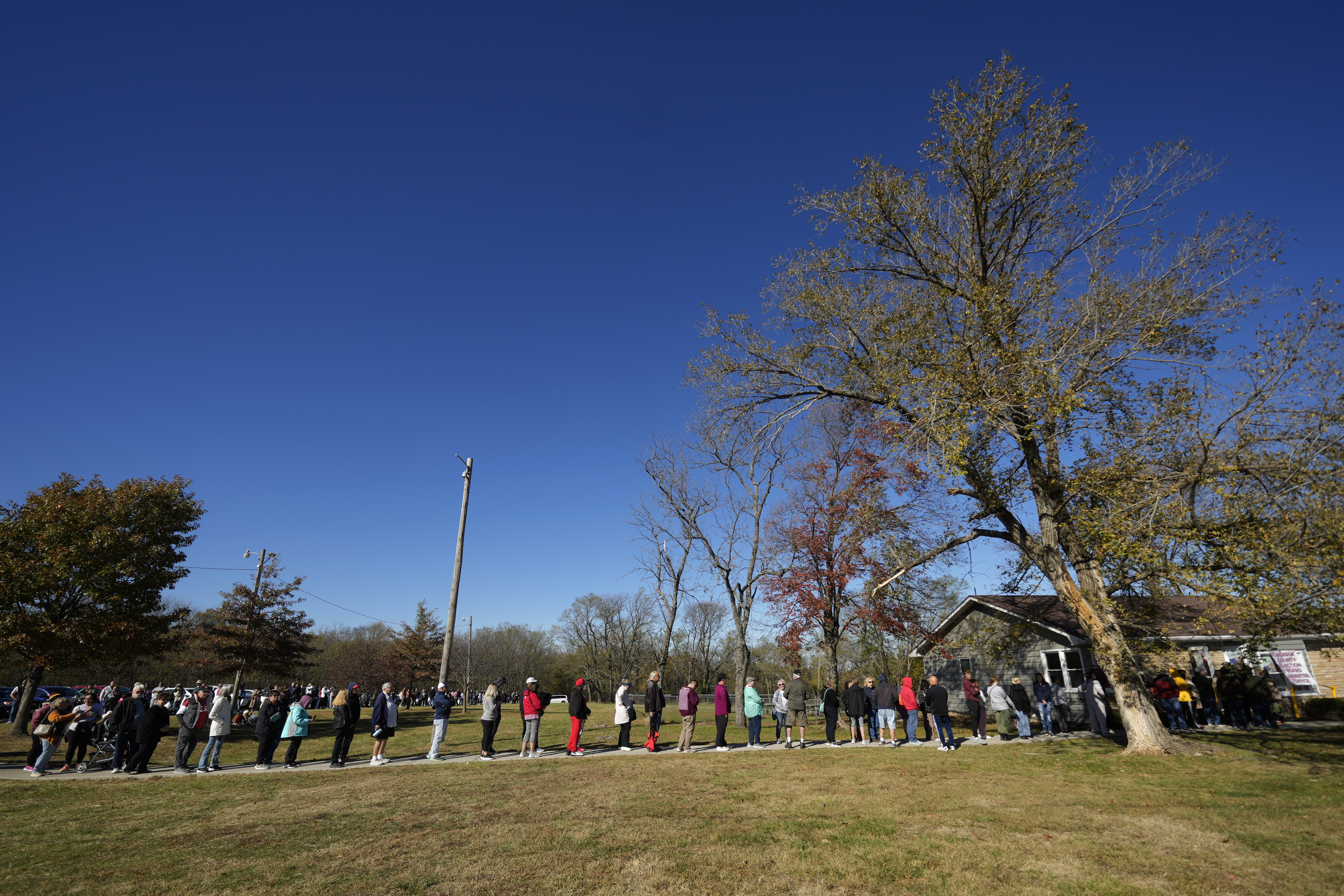 People wait in line to cast their ballots at an early voting location, Thursday, Oct. 31, 2024, in Blue Springs, Mo. (AP Photo/Charlie Riedel)