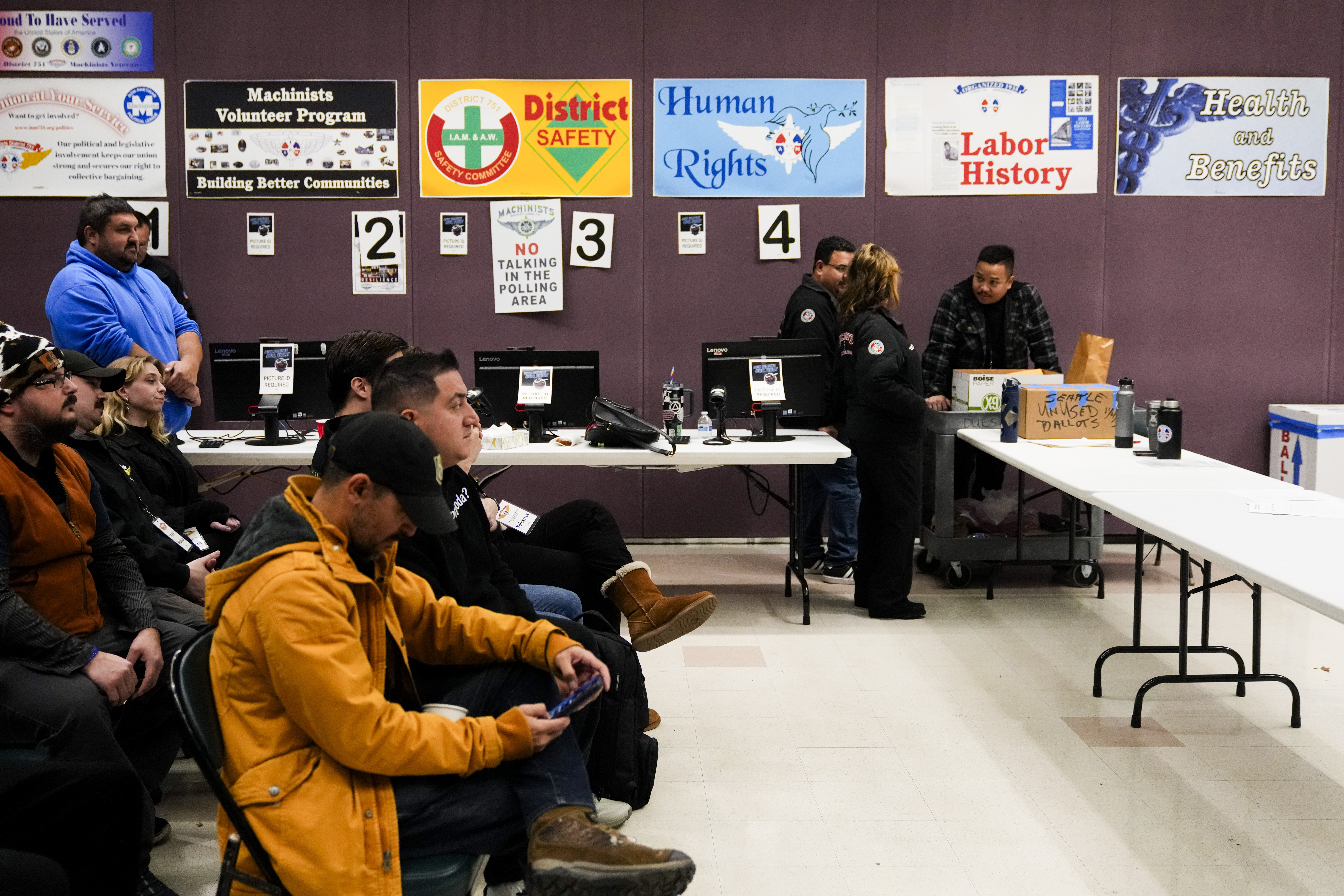 Observers watch as volunteers tally votes on a new contract offer from Boeing, Monday, Nov. 4, 2024, at IAM District 751 Union Hall in Seattle. (AP Photo/Lindsey Wasson)