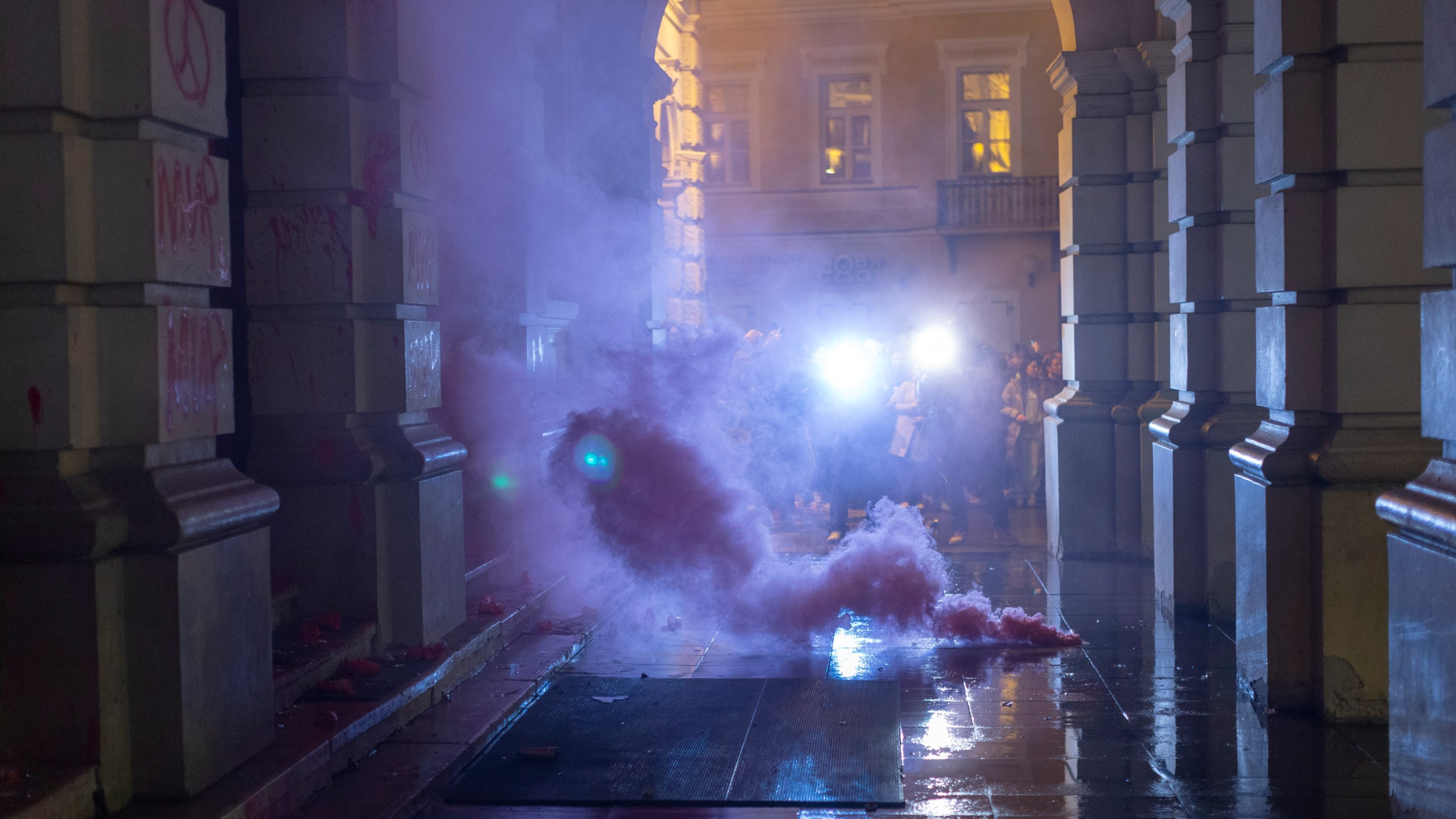 A flare burns in front of the City Hall building during a protest in rage over last week's collapse of a concrete canopy at the railway station that killed 14 people, in Novi Sad, Serbia, Tuesday, Nov. 5, 2024. (AP Photo/Marko Drobnjakovic)