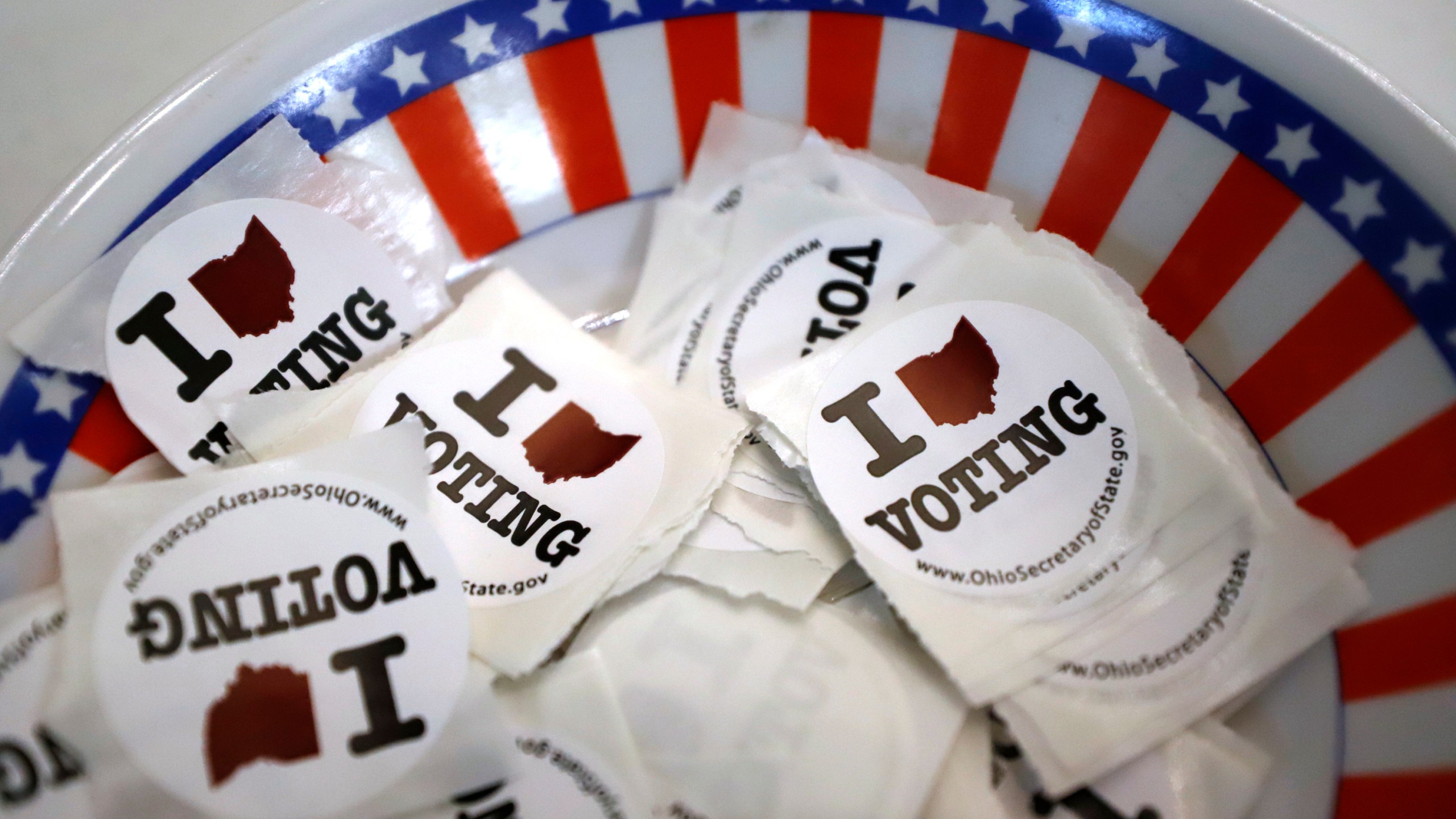 FILE - A bowl of voting stickers for early voters is shown March 15, 2020, in Steubenville, Ohio. (AP Photo/Gene J. Puskar, File)