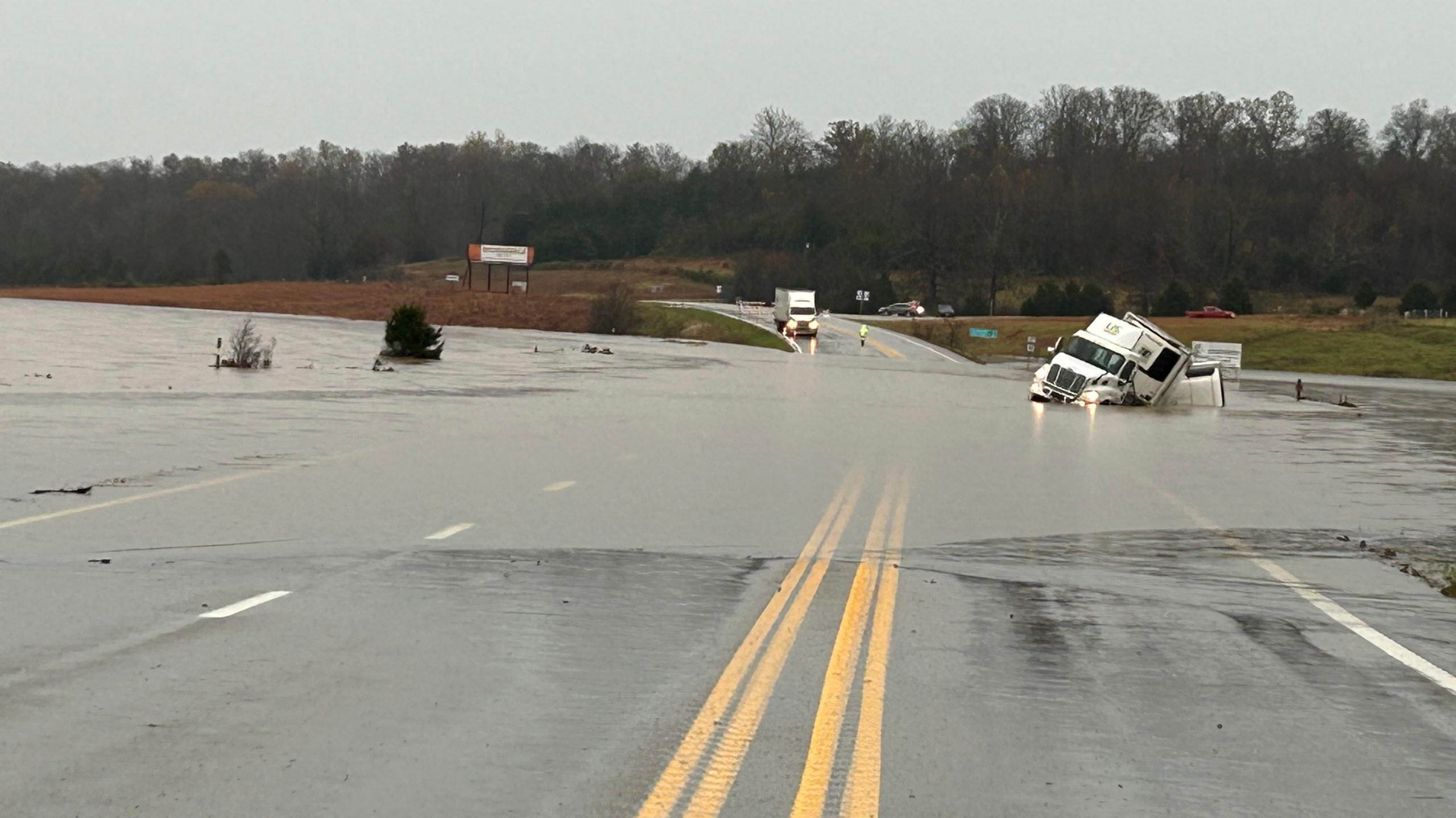 In a photo released by the Missouri State Highway Patrol, tractor trailer sits submerged in flood water on US 63 just north of Cabool, Mo., Tuesday, Nov. 5, 2024. (Missouri State Highway Patrol via AP)