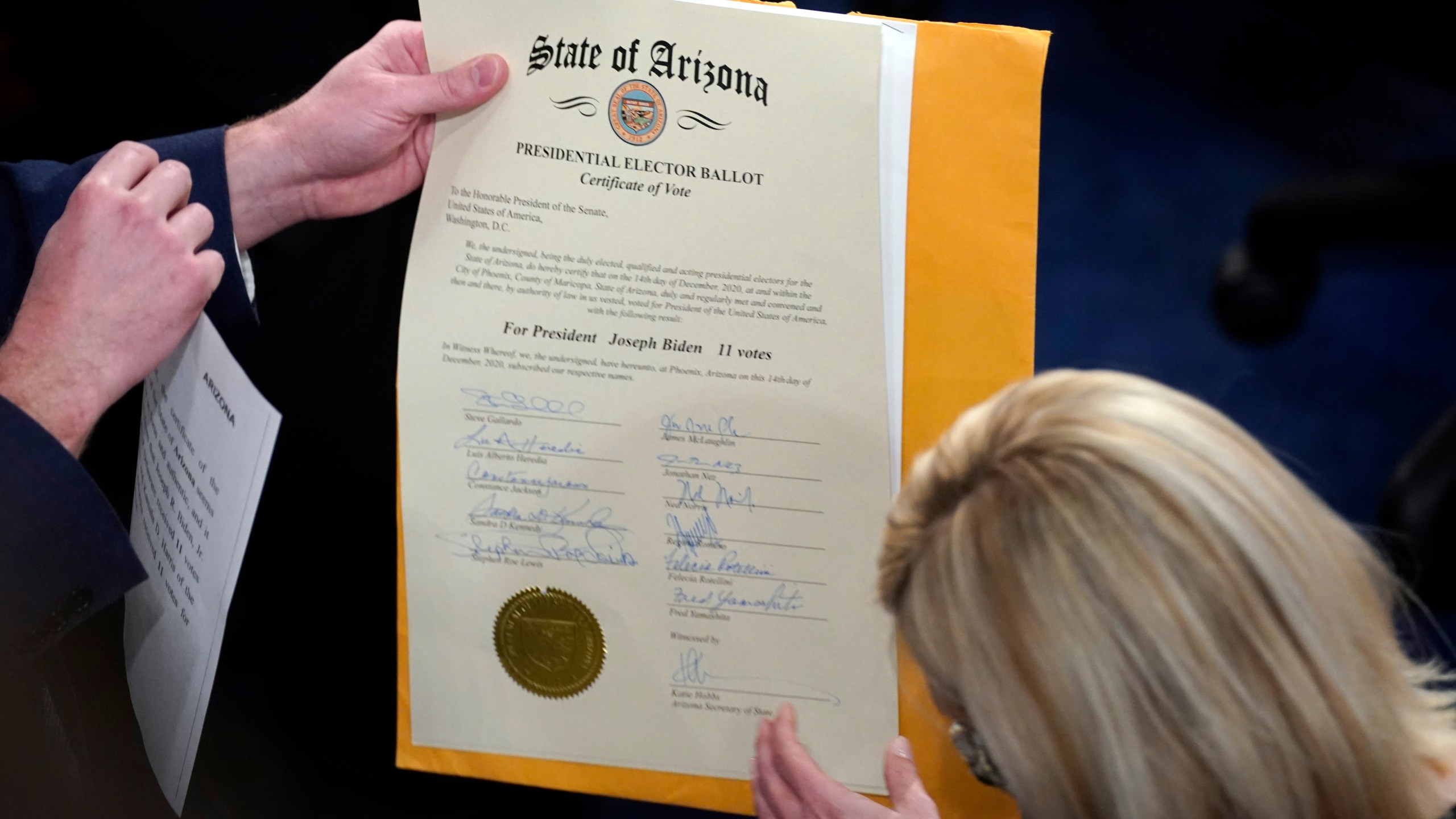 FILE - The certification of Electoral College votes for the state of Arizona is unsealed during a joint session of the House and Senate convenes to confirm the electoral votes cast in November's election, at the Capitol, Jan 6, 2021. (AP Photo/Andrew Harnik, File)