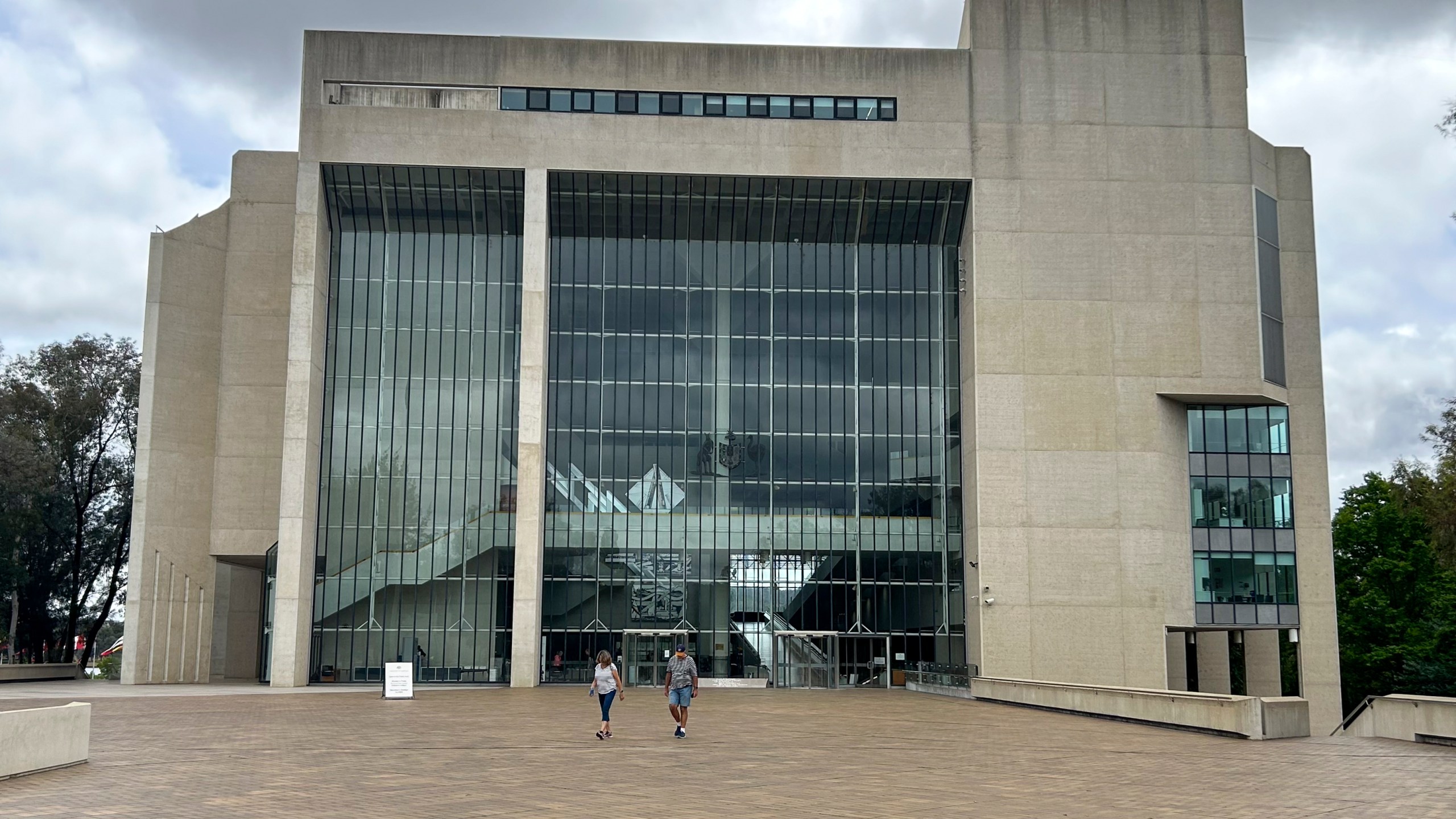 FILE - People walk outside the High Court building in Canberra, Australia, on Nov. 23, 2023. (AP Photo/Rod McGuirk, File)