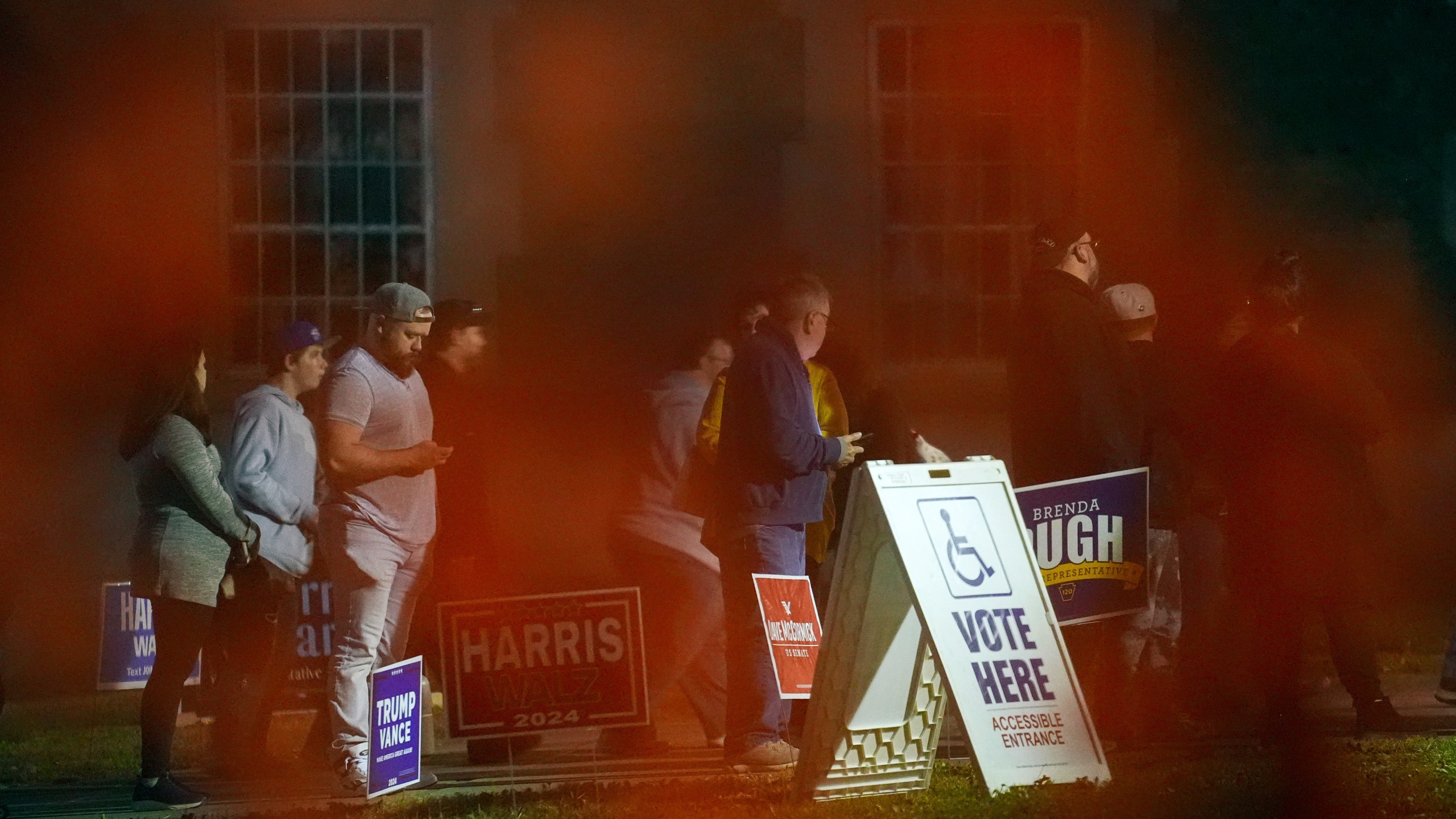 Voters wait in line to cast their ballots at the Kingston Armory in Wilkes-Barre, Pa, Tuesday, Nov. 5, 2024. (AP Photo/Matt Rourke)